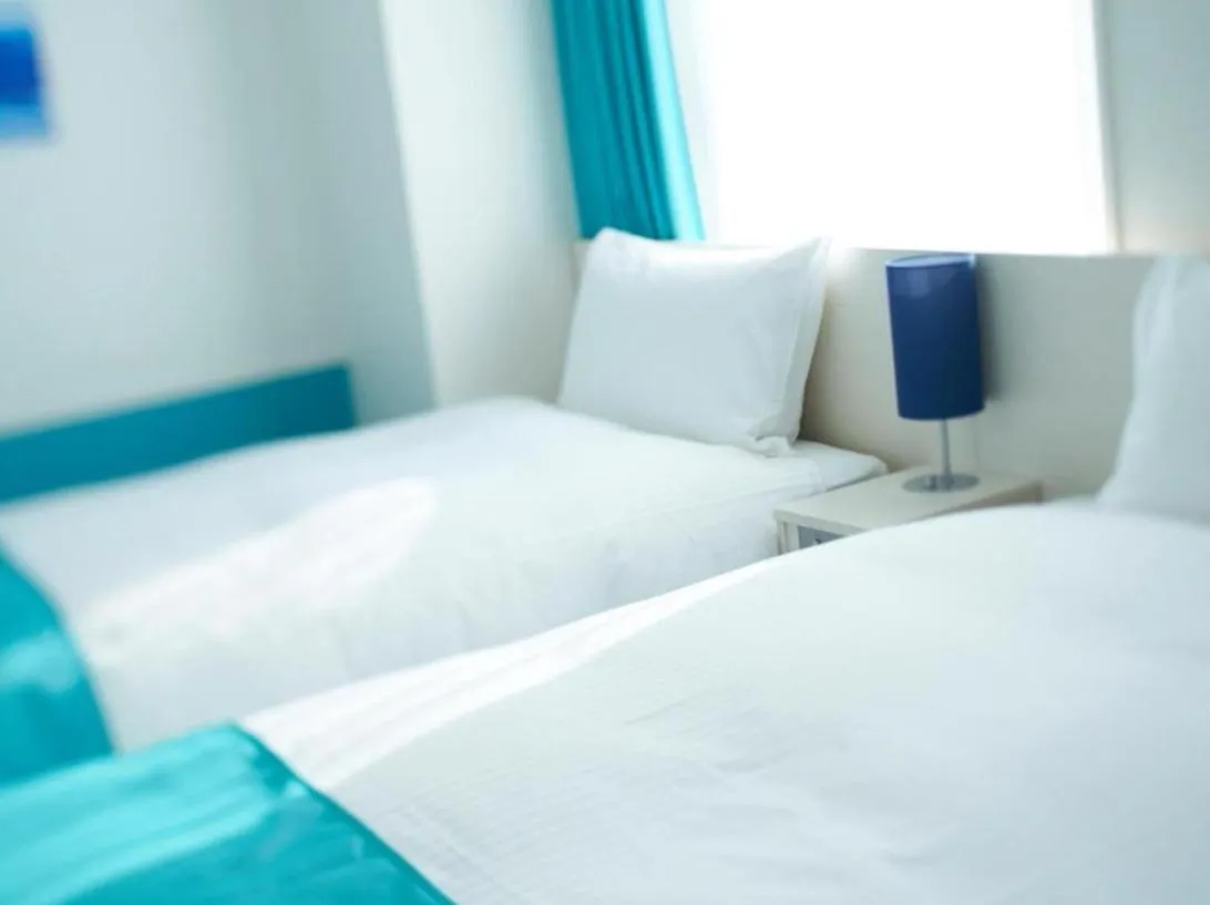 Bed in DEL style Osaka Shin Umeda by Daiwa Roynet Hotel