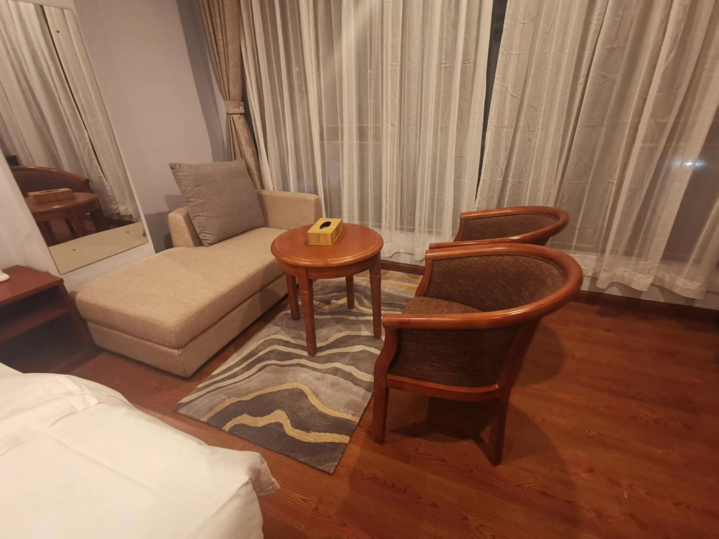 Seating area, Bed in Ludrong Hotel