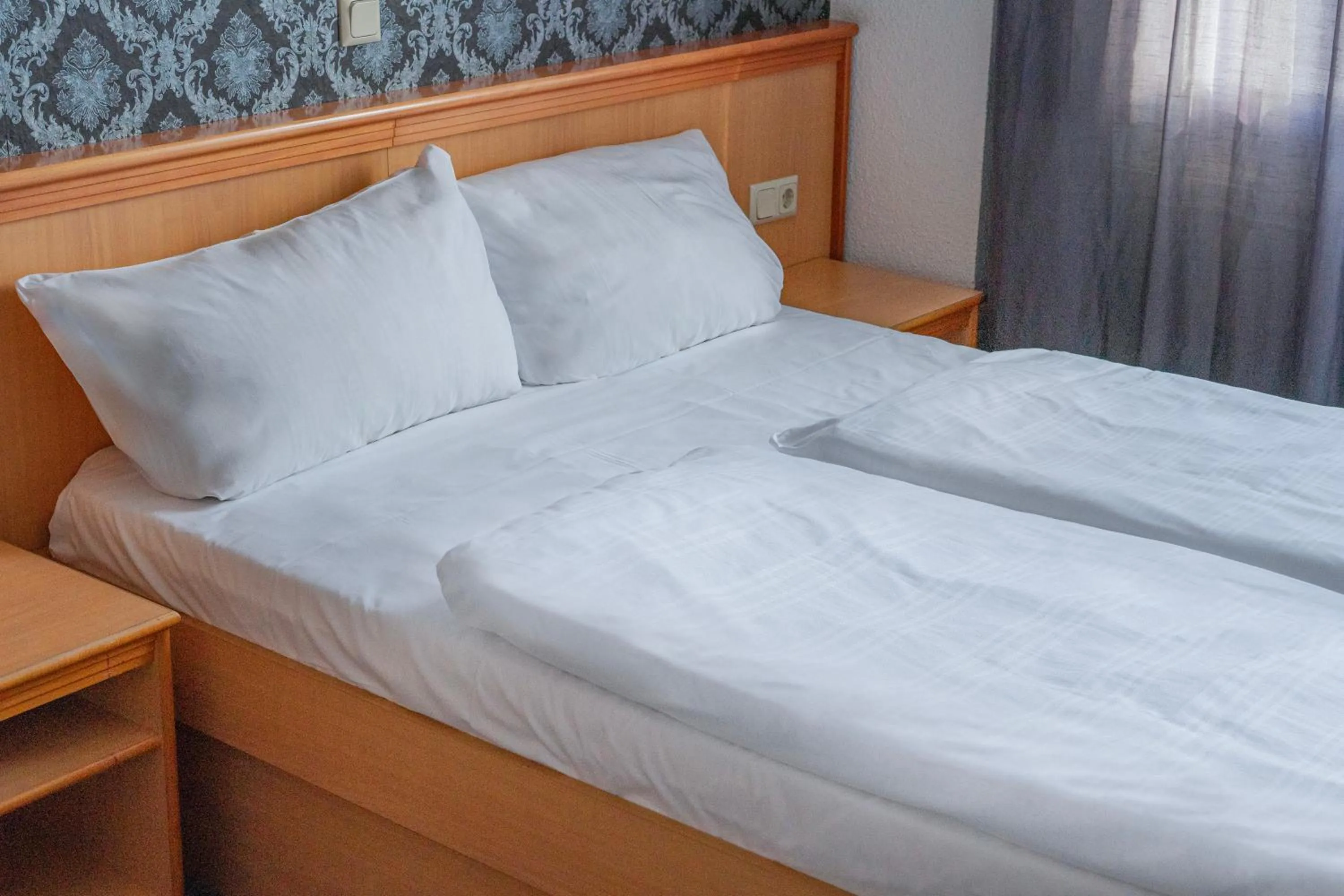 Bed in Self-Check-In Hotel Constantin