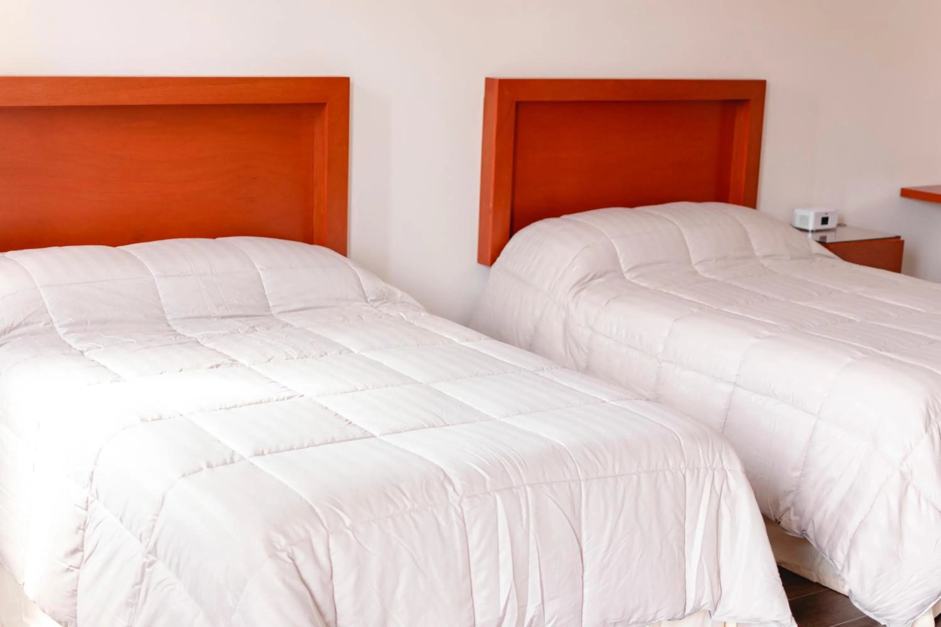 Bed in La Lola Hotel & Suites