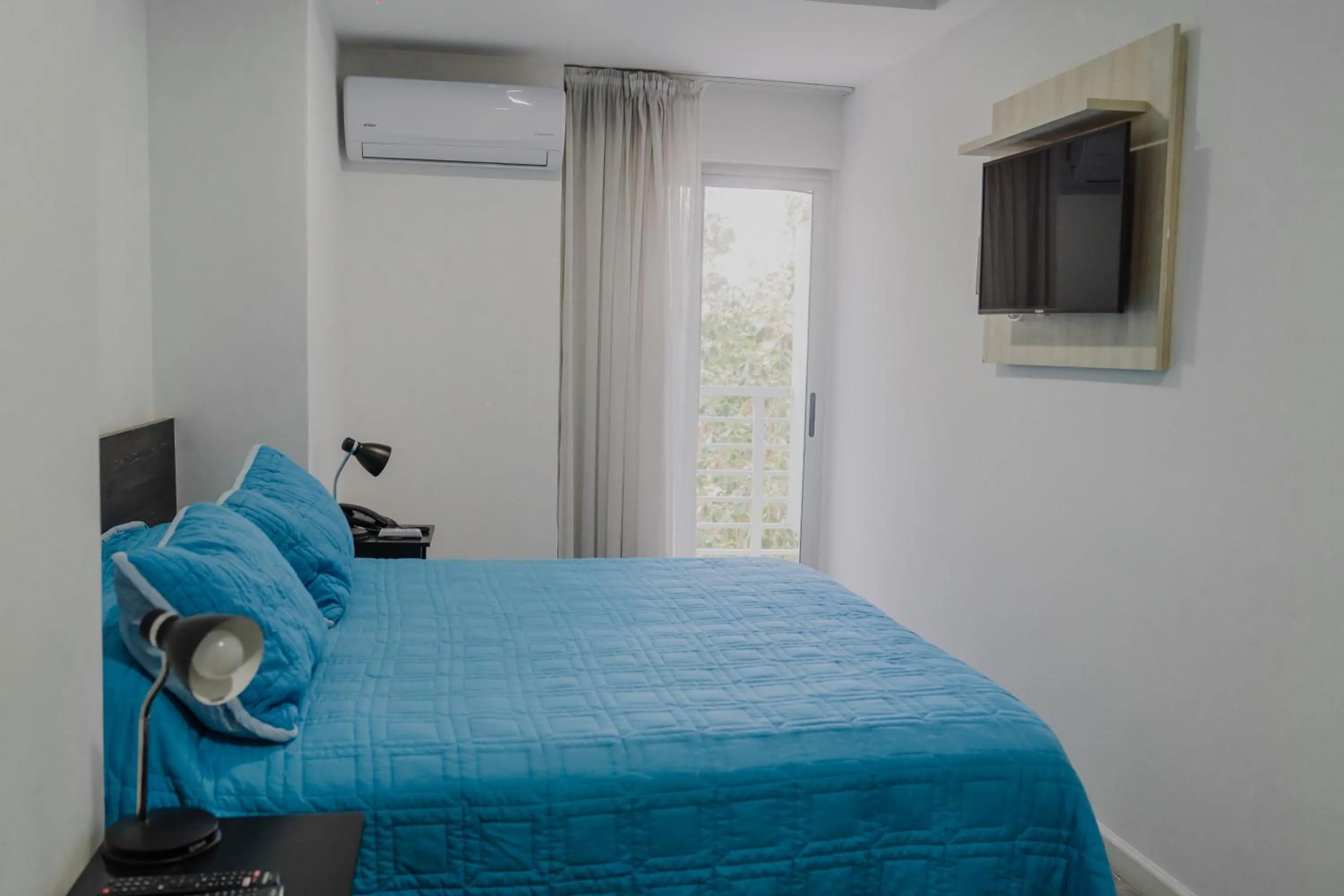 Bed in Quijano Hotel - Aparts & Suites