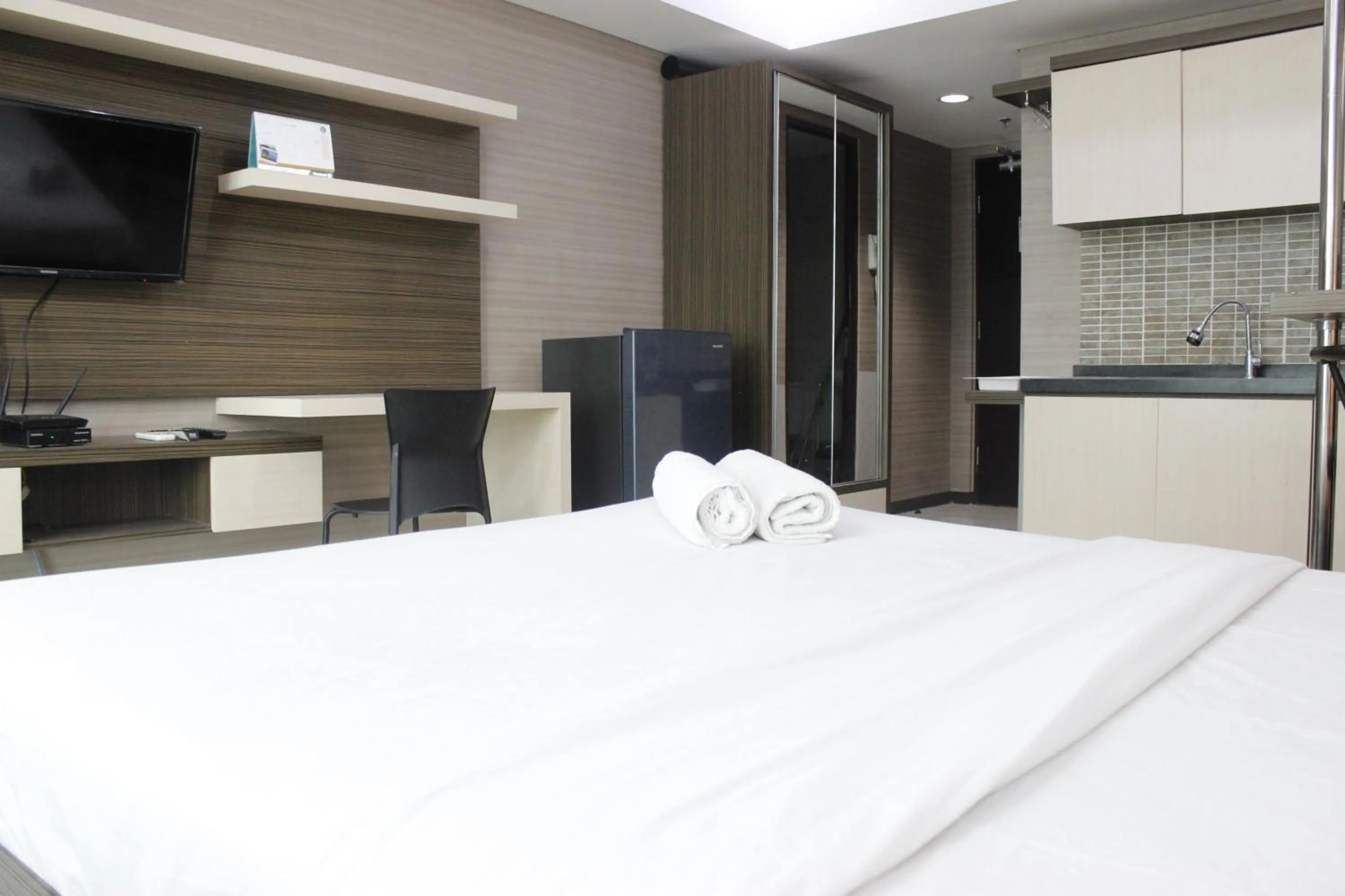 Photo of the whole room, Bed in Prime and Comfy Studio at Tamansari La Grande Apartment By Travelio