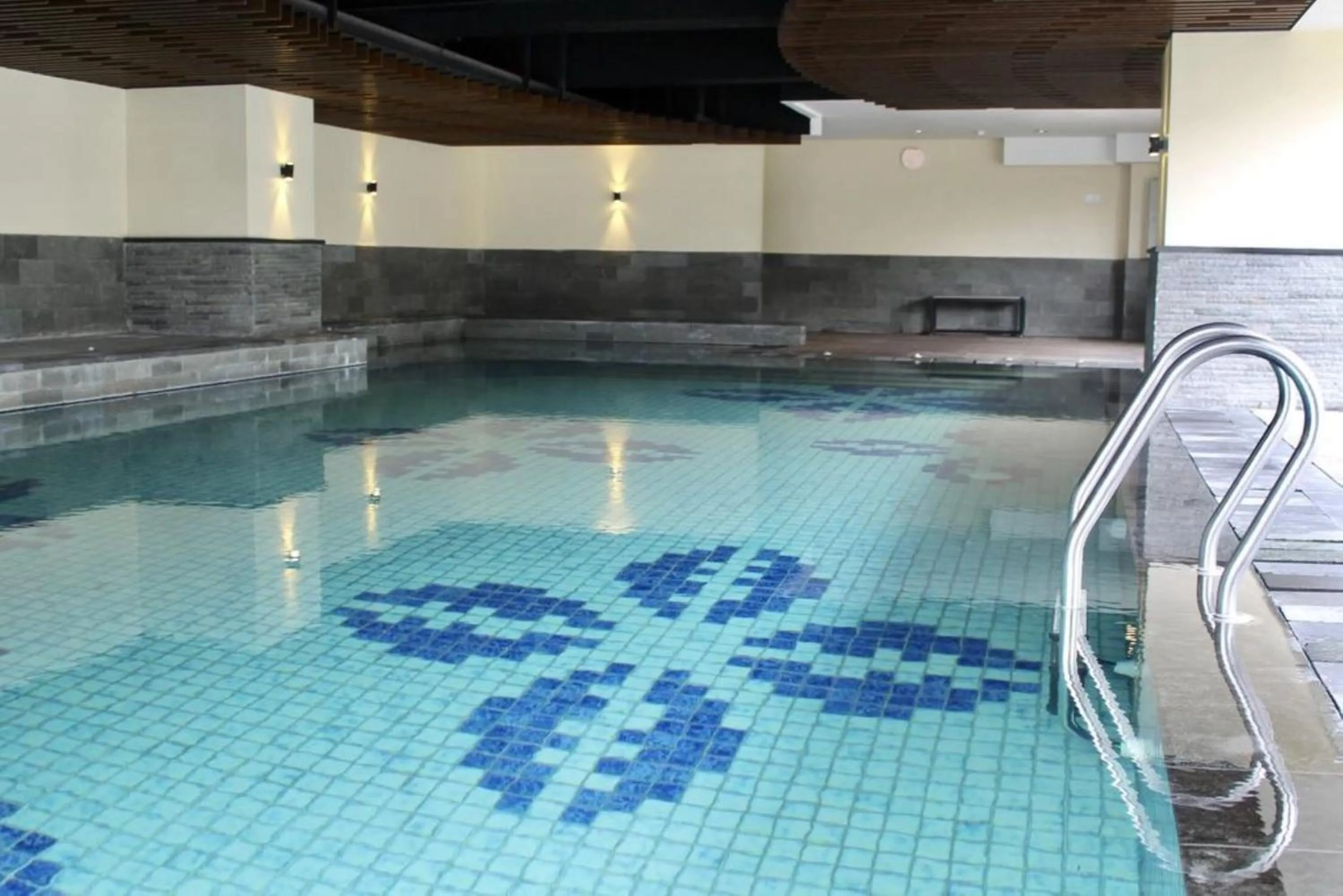 Swimming pool in Prime and Comfy Studio at Tamansari La Grande Apartment By Travelio