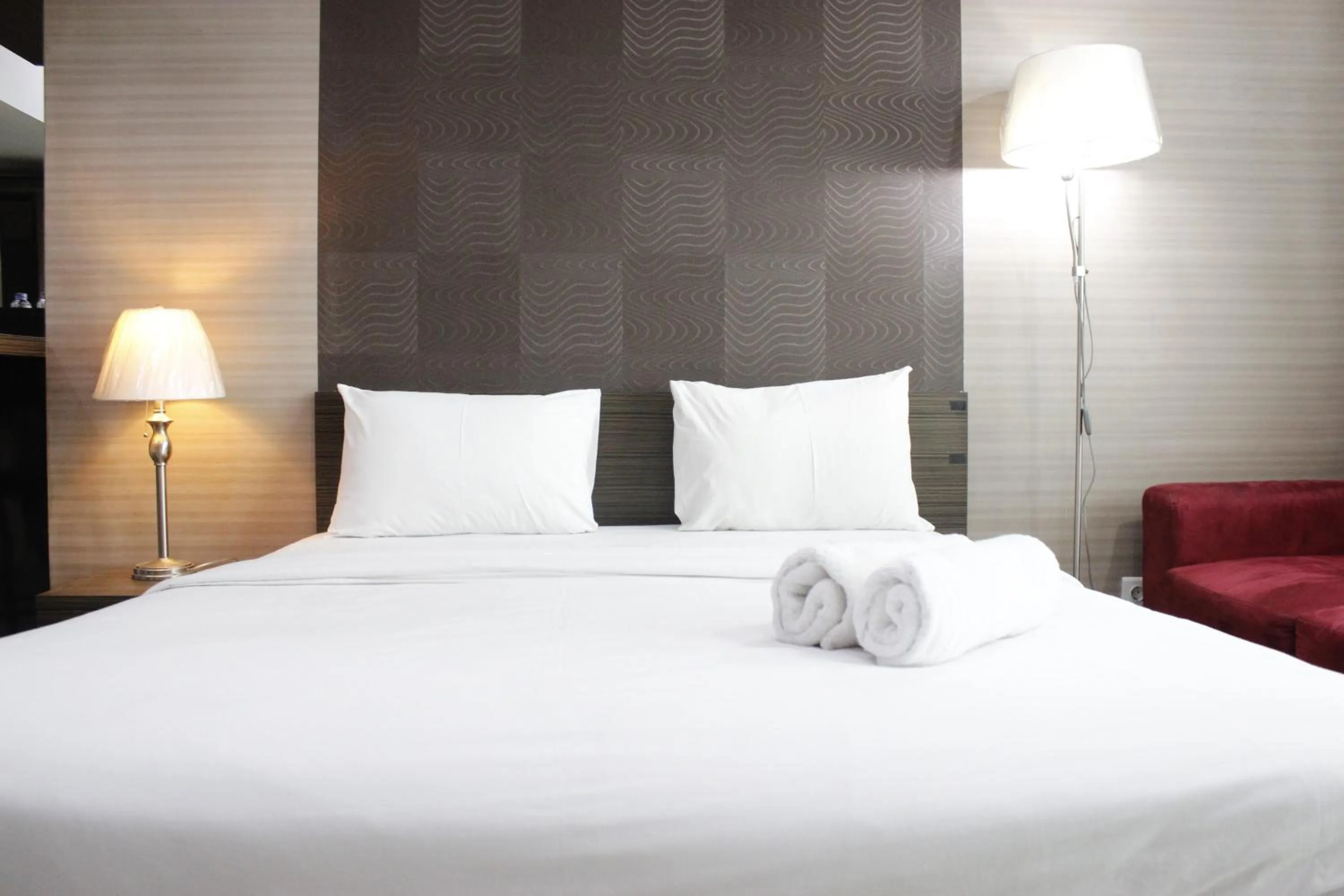 Bed in Prime and Comfy Studio at Tamansari La Grande Apartment By Travelio