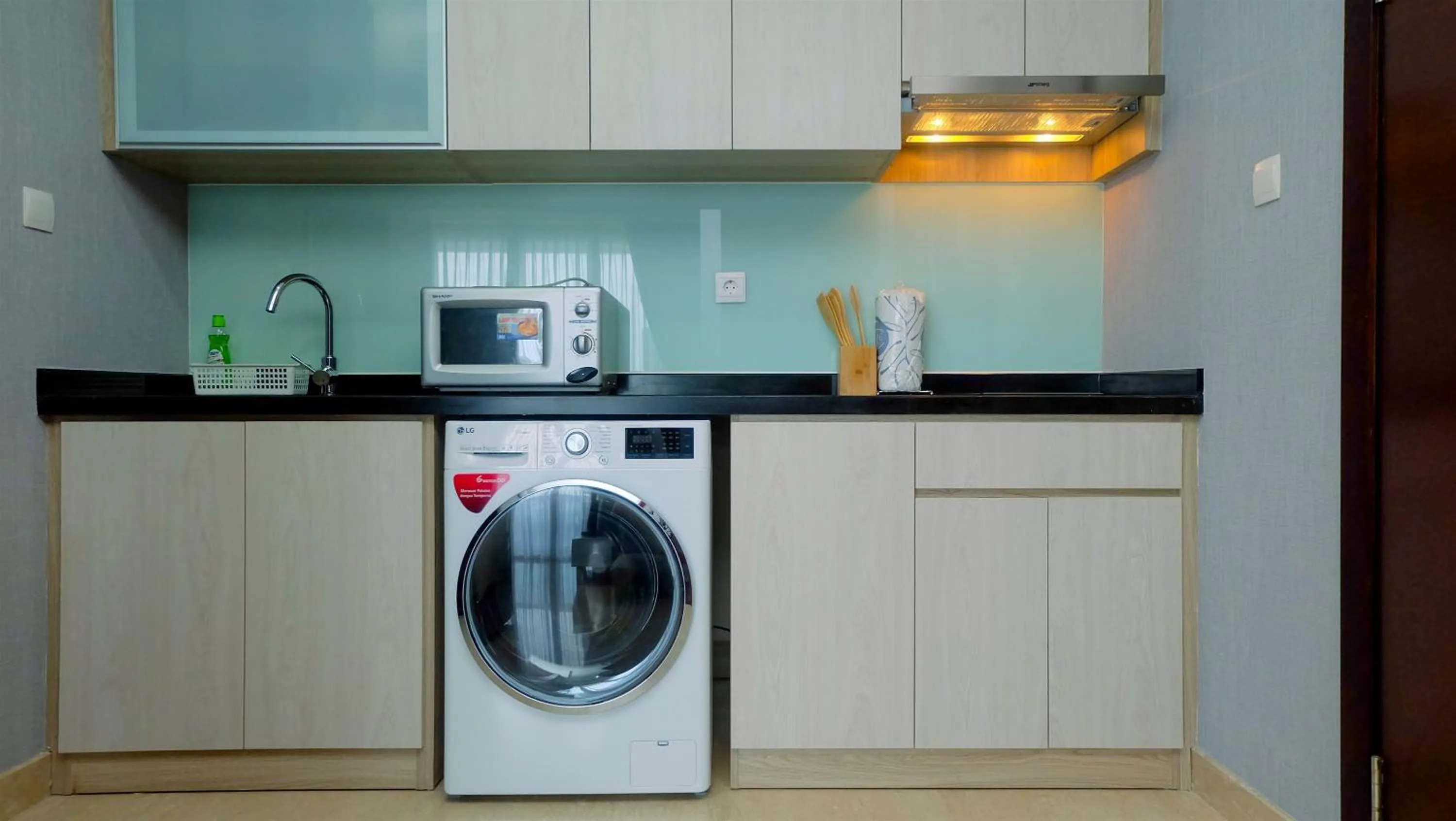 Kitchen or kitchenette in Classy 2BR Apartment at Menteng Park with City View By Travelio