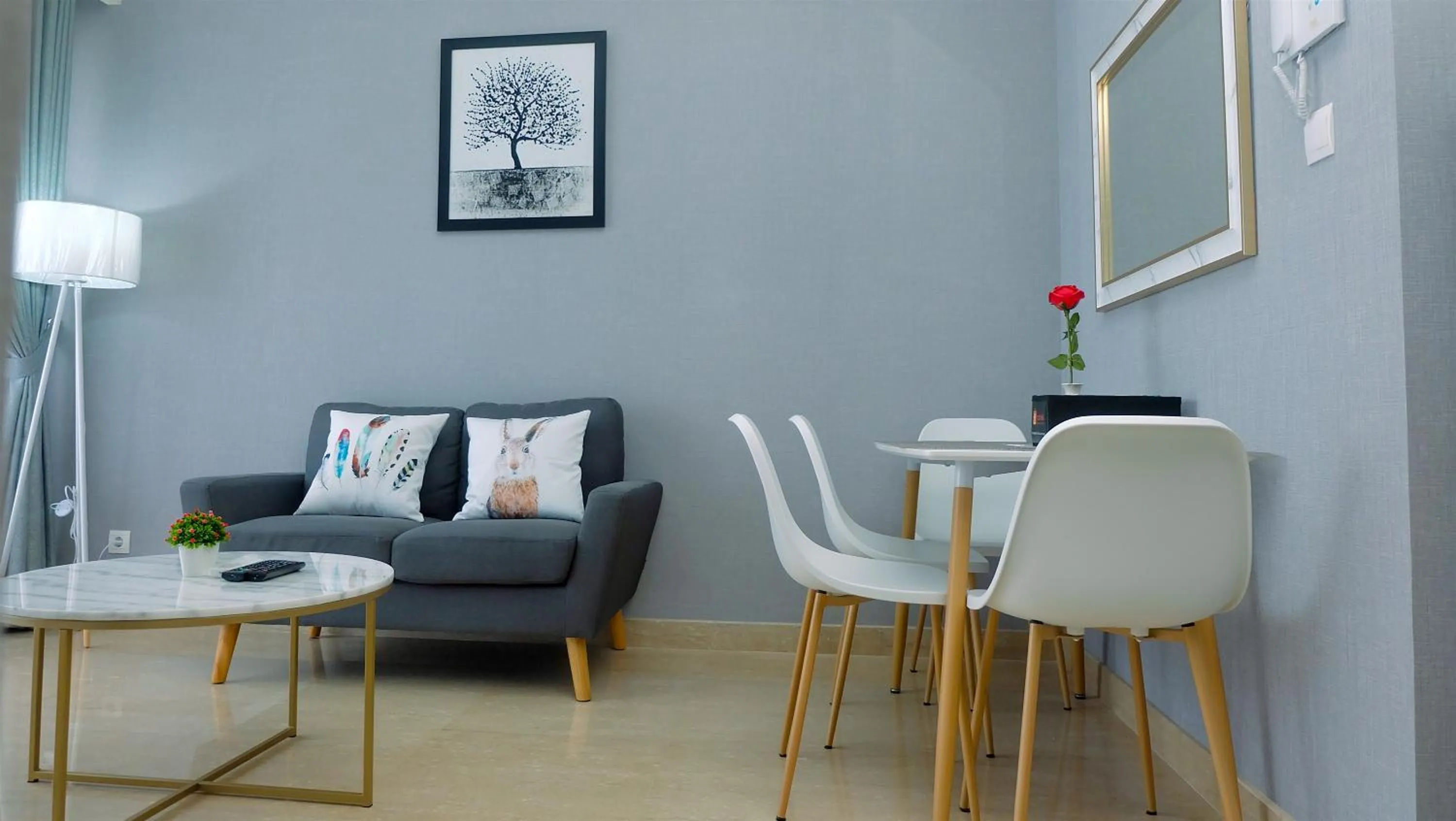 Living room in Classy 2BR Apartment at Menteng Park with City View By Travelio