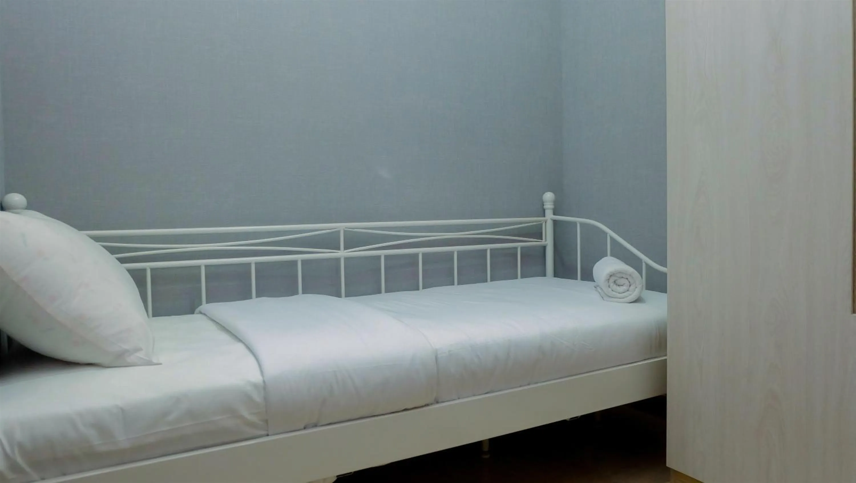 Bed in Classy 2BR Apartment at Menteng Park with City View By Travelio