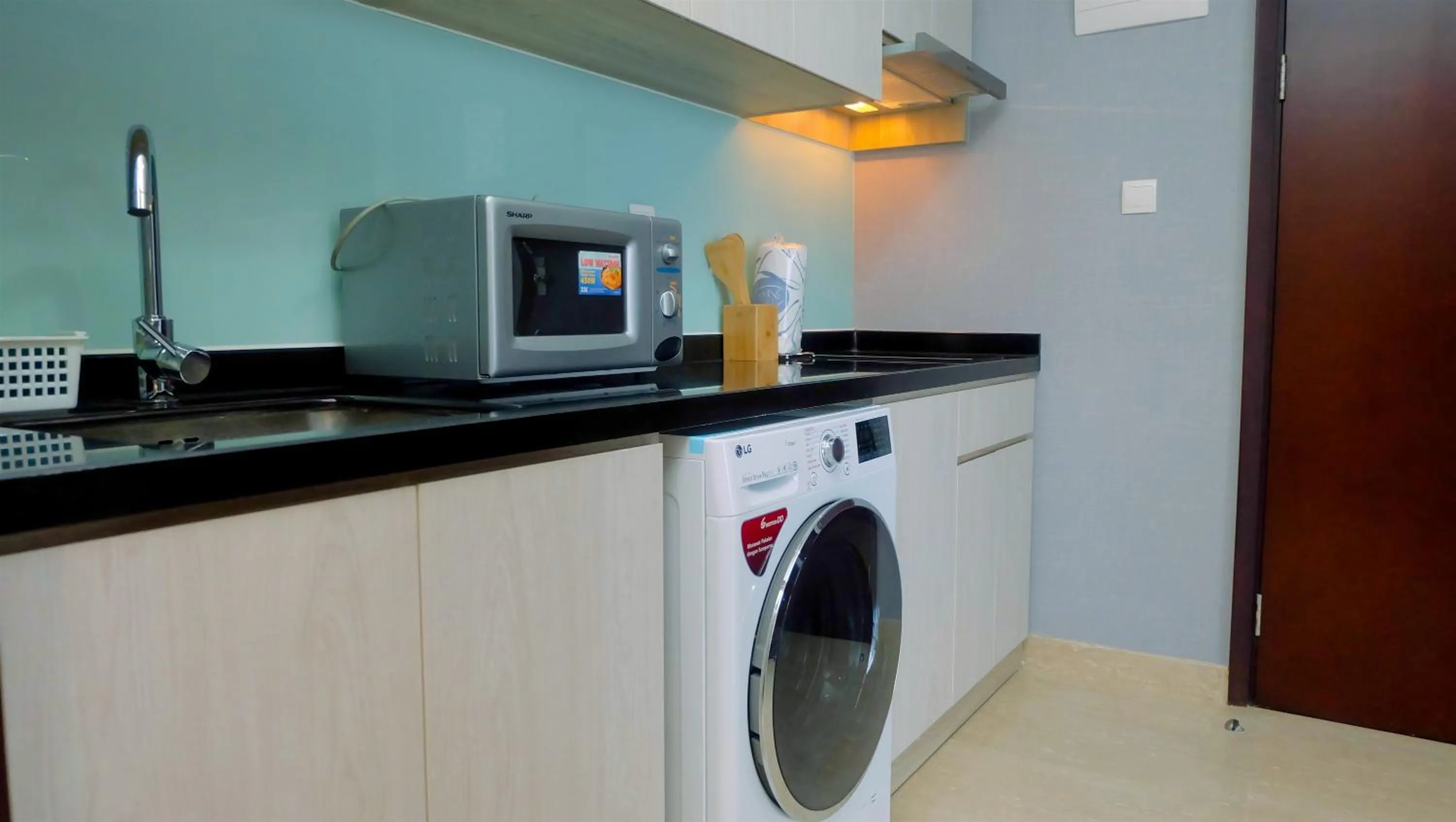 Kitchen or kitchenette in Classy 2BR Apartment at Menteng Park with City View By Travelio