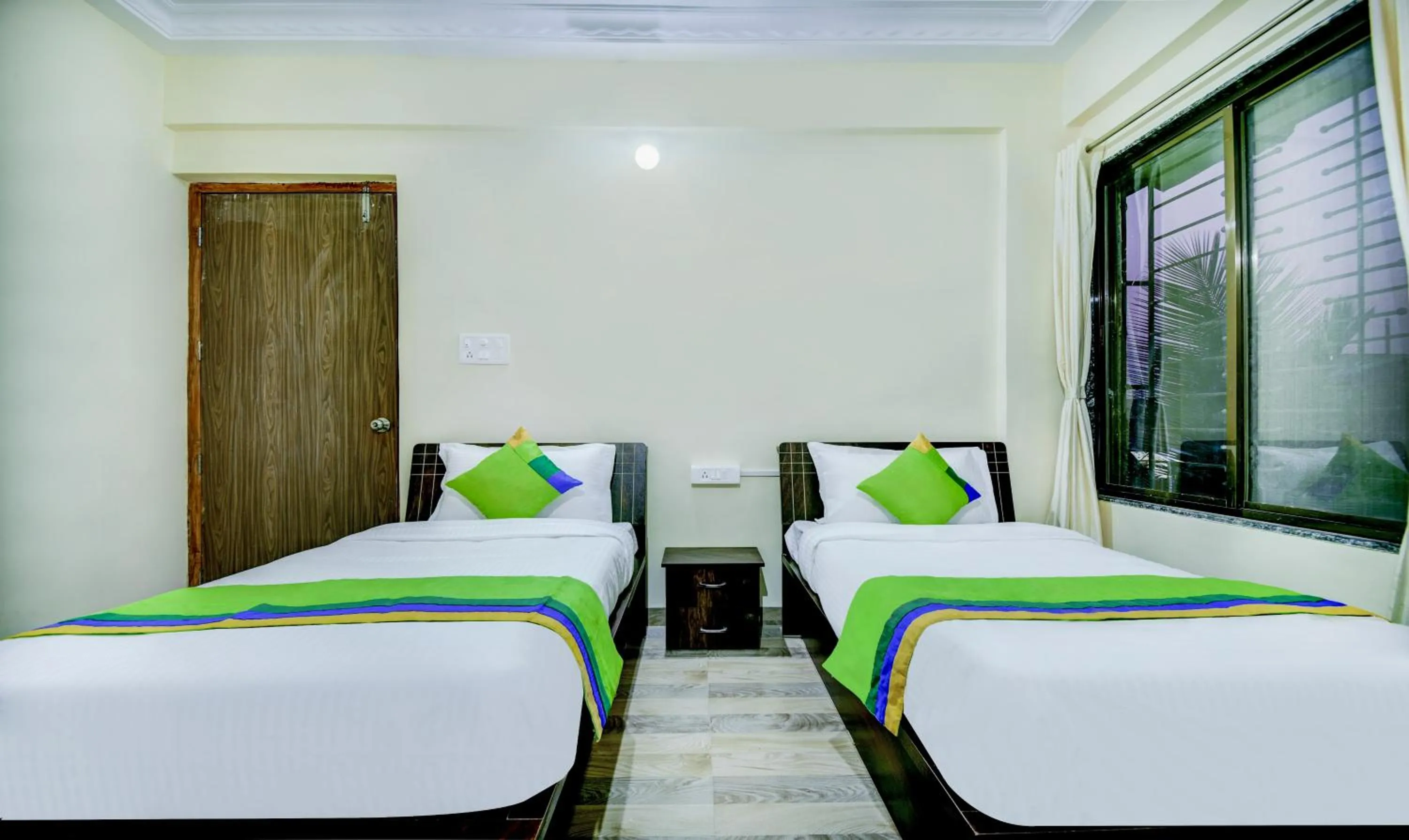 Bed in Treebo Sayaji Residency