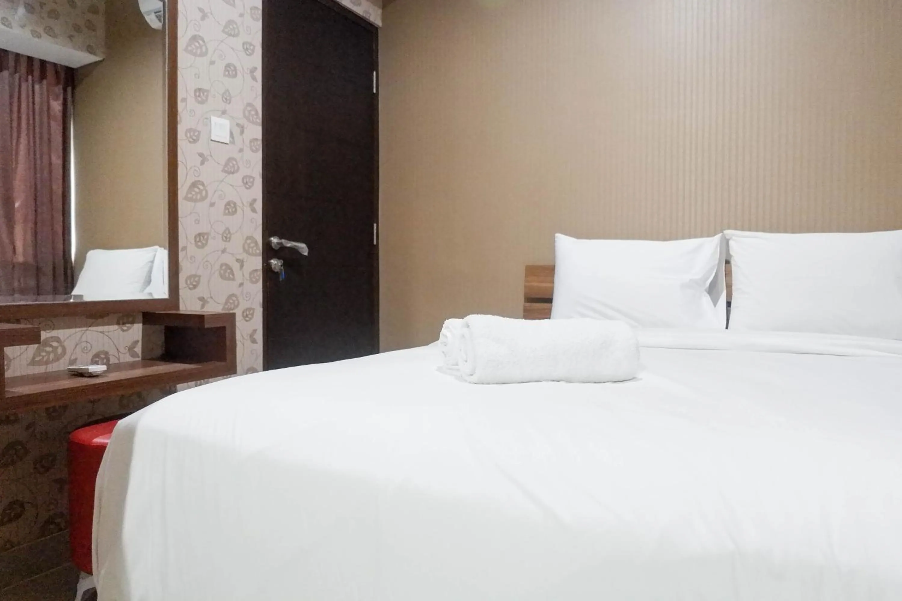 Bed in Minimalist 2BR Apartment at Tamansari Papilio By Travelio