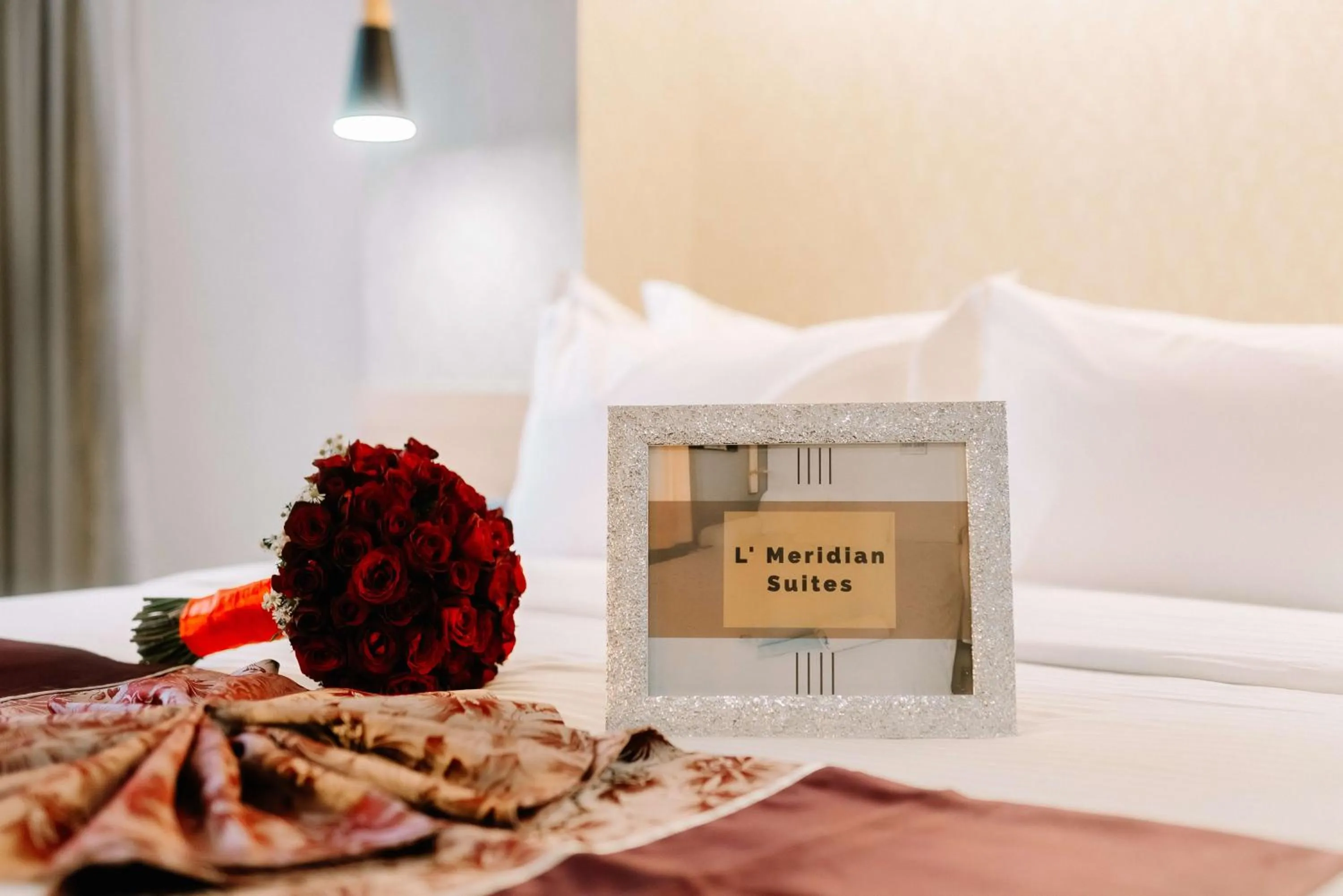 Bed in L' Meridian Suites