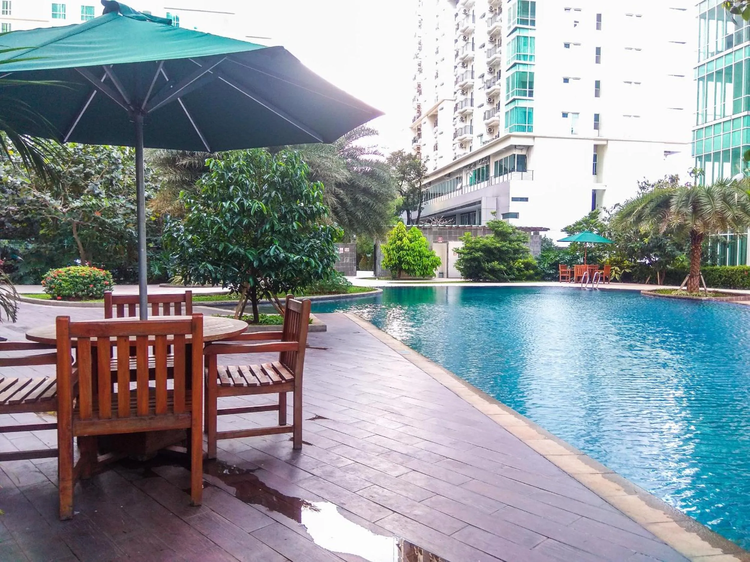 Swimming pool in Good Location with Simply Furnished 1BR Apartment Woodland Park Residence By Travelio