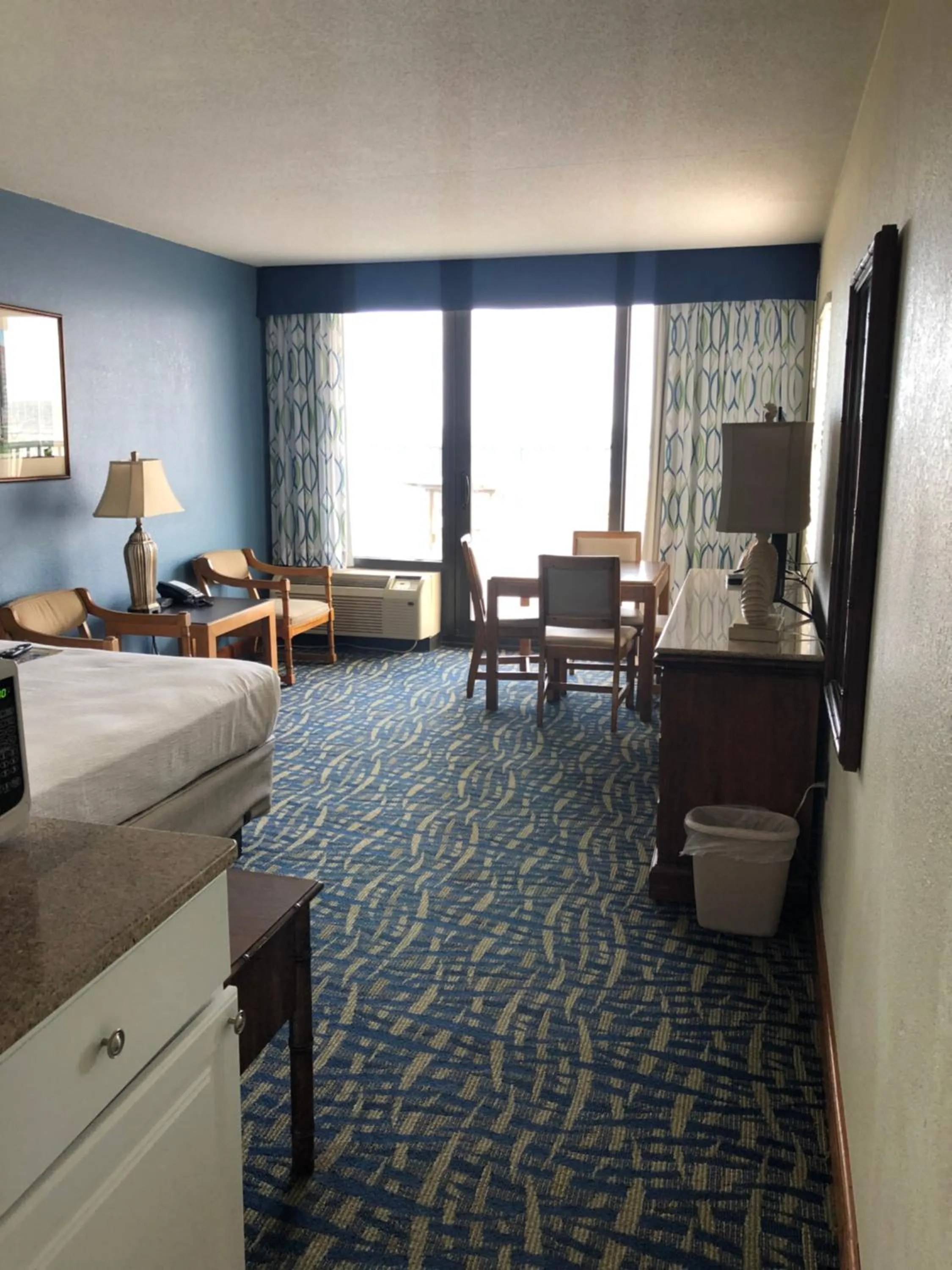 Seating area, Bed in Capes Hotel