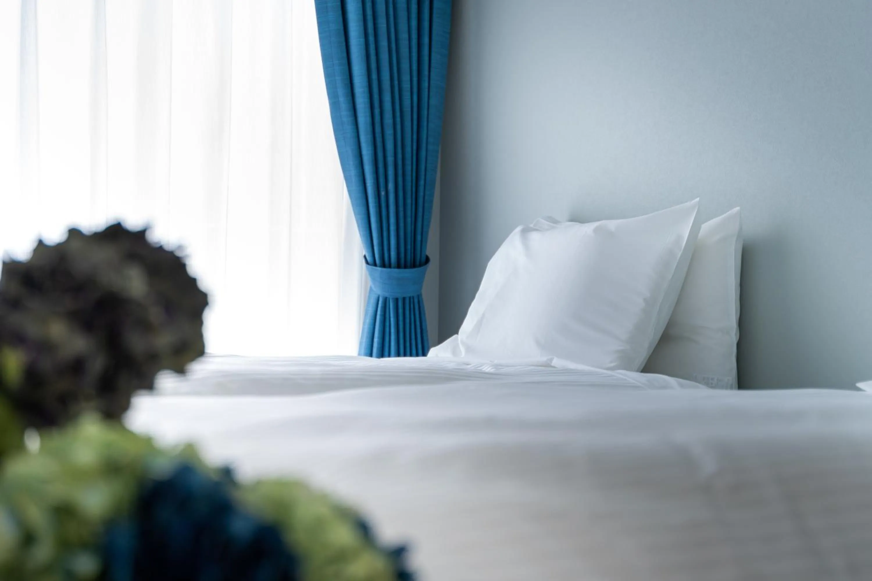 Bed in Tenpoint Hotel OKOU