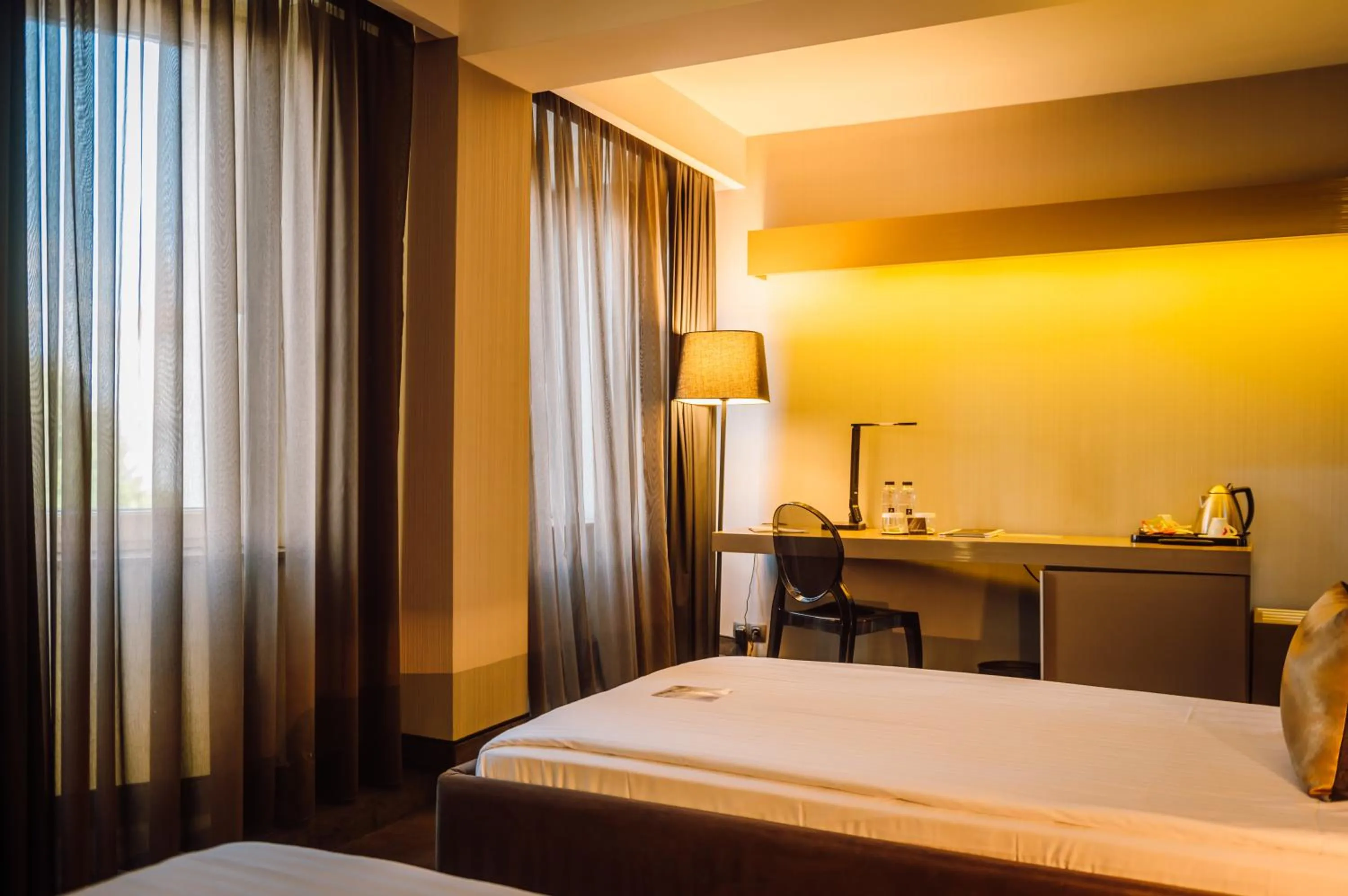 Bed in Plaza V Executive Hotel