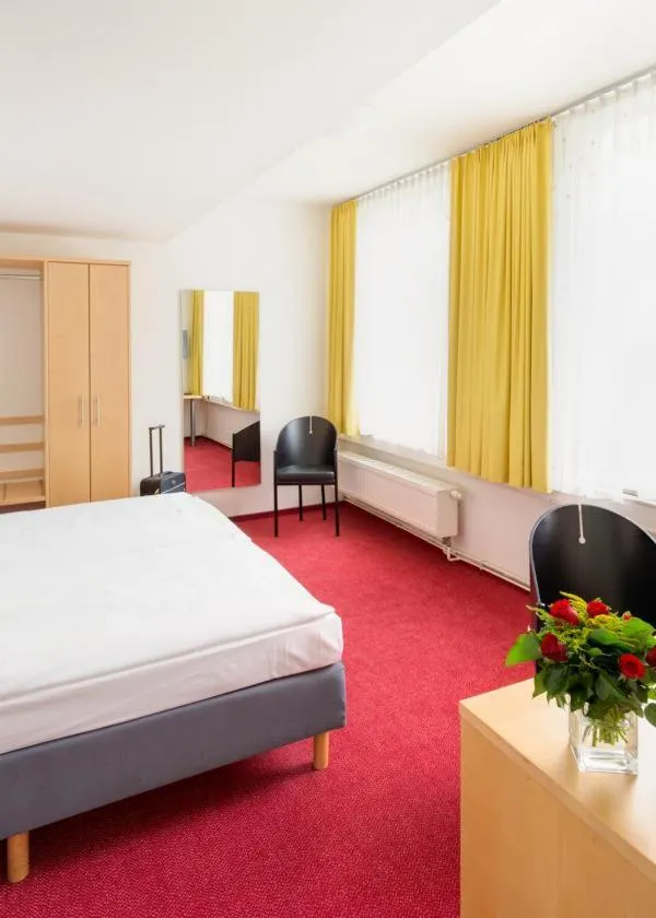 Photo of the whole room, Bed in CVJM Düsseldorf Hotel & Tagung