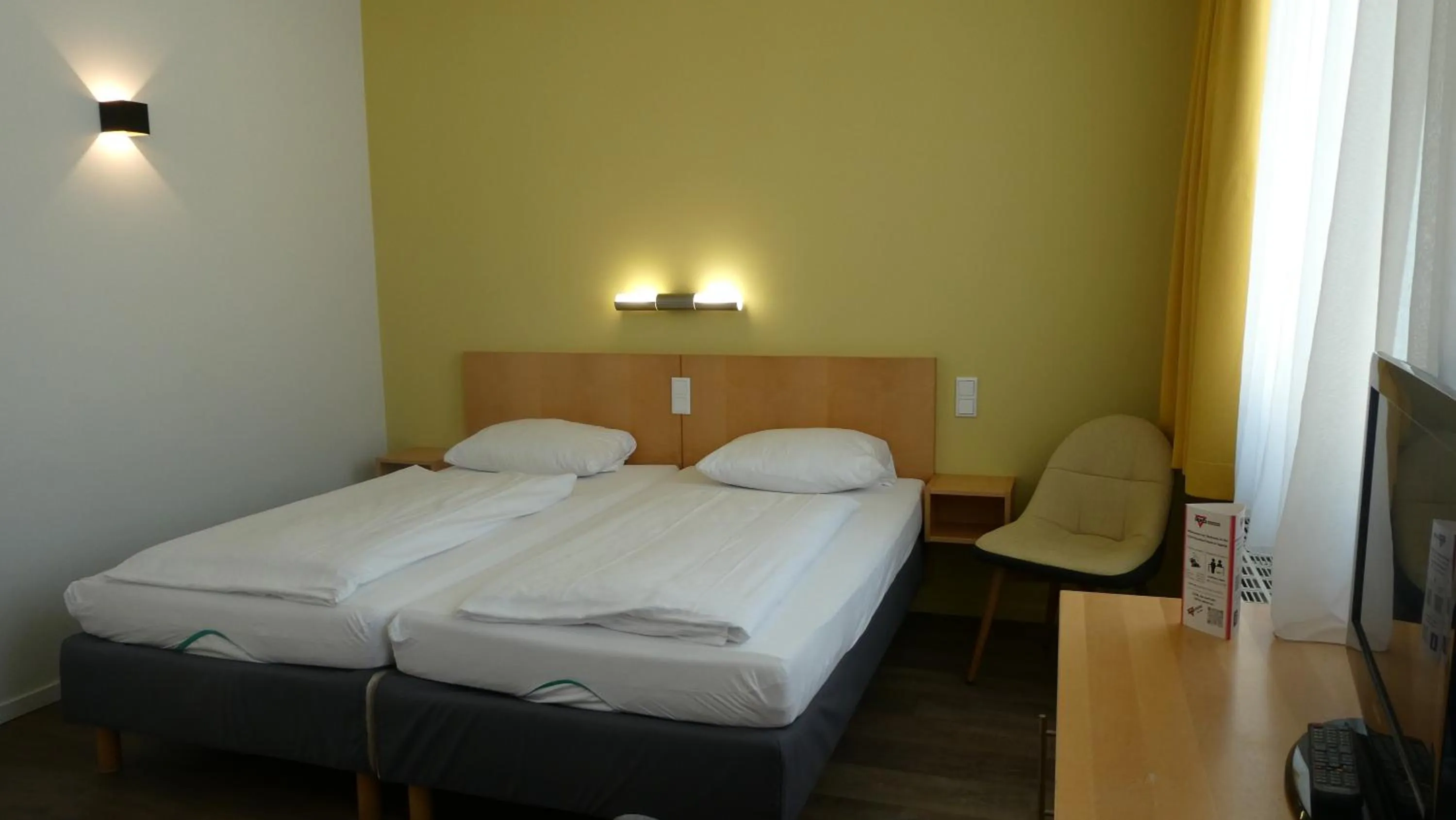 Photo of the whole room, Bed in CVJM Düsseldorf Hotel & Tagung