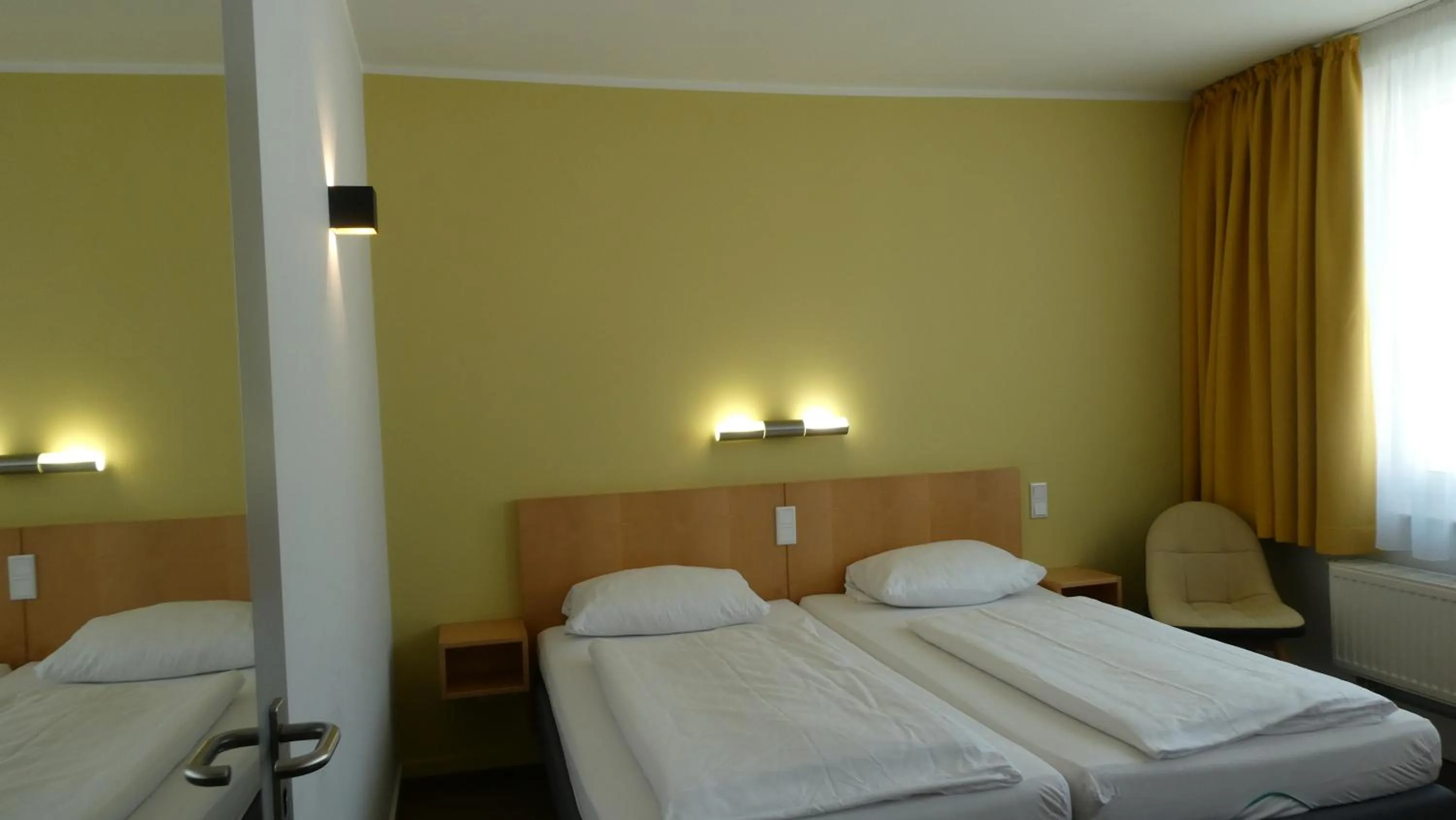 Photo of the whole room, Bed in CVJM Düsseldorf Hotel & Tagung