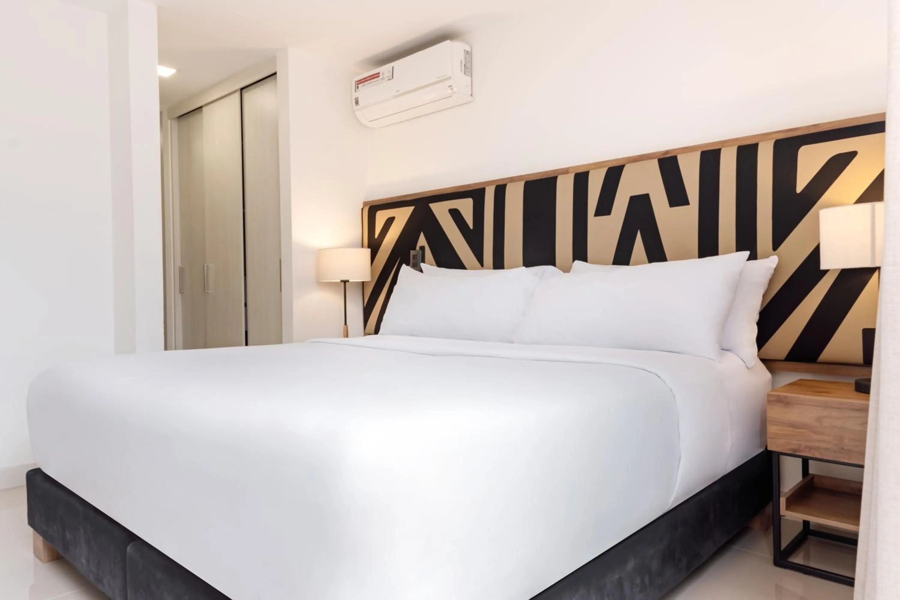 Bed in Origen Local Suites