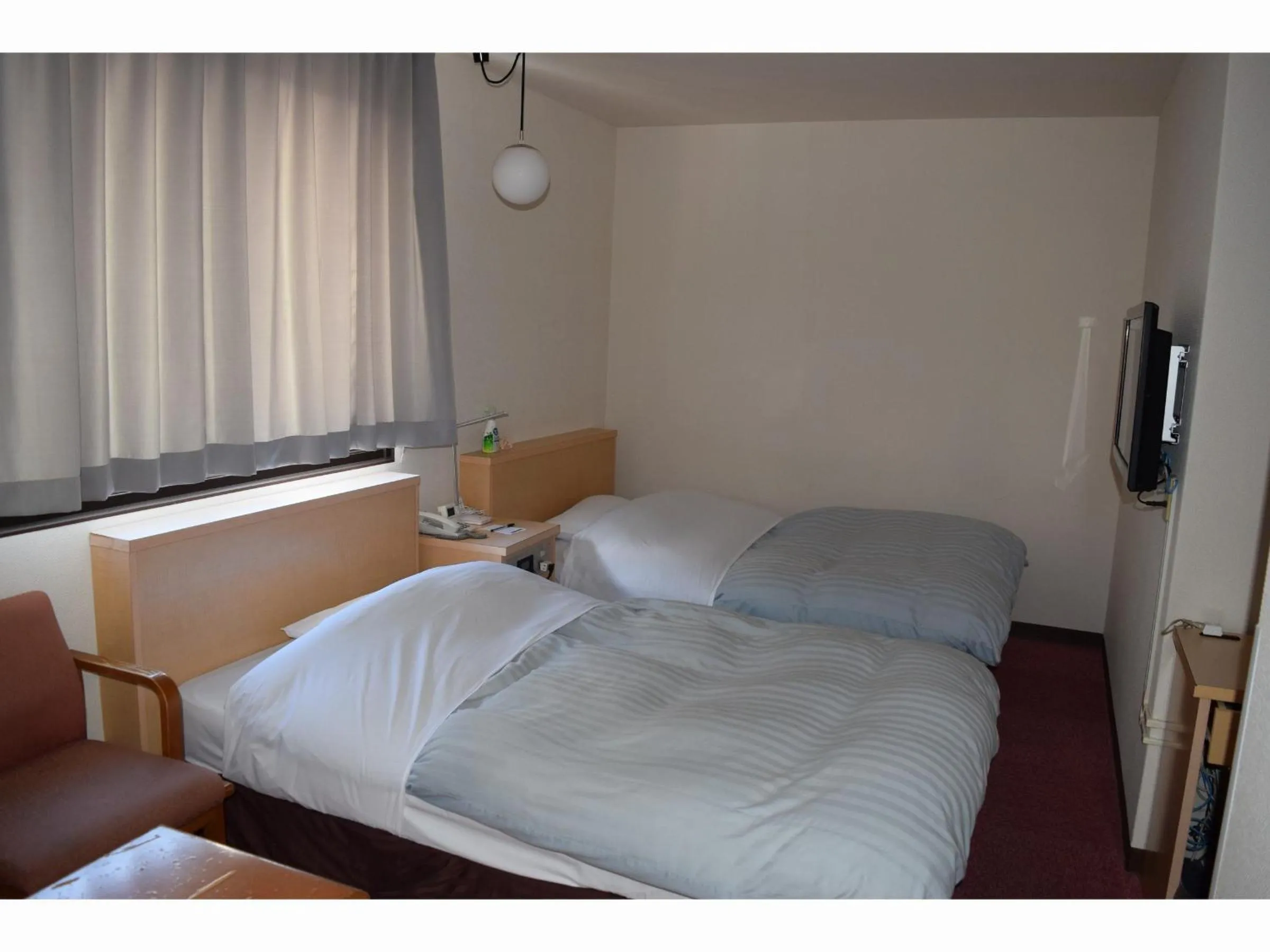 Bed in Amami Port Tower Hotel