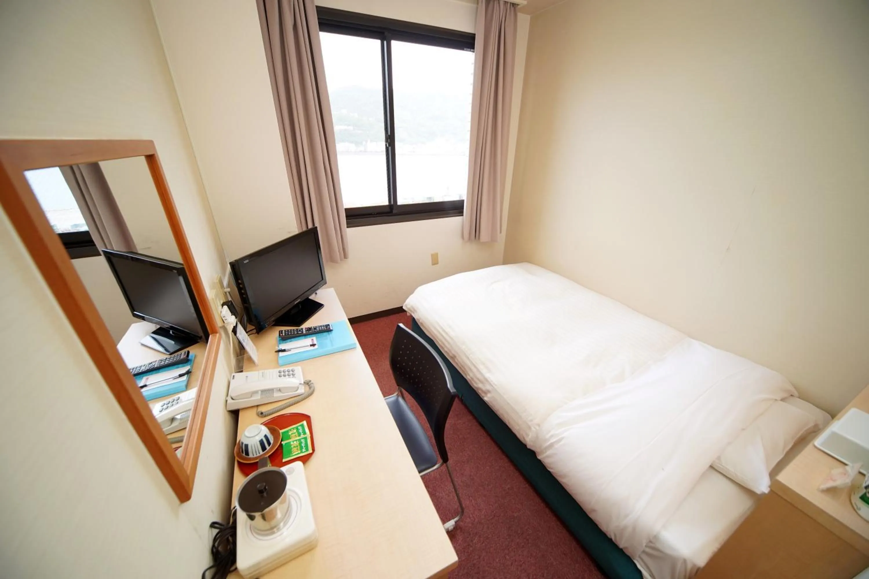 Bed in Amami Port Tower Hotel