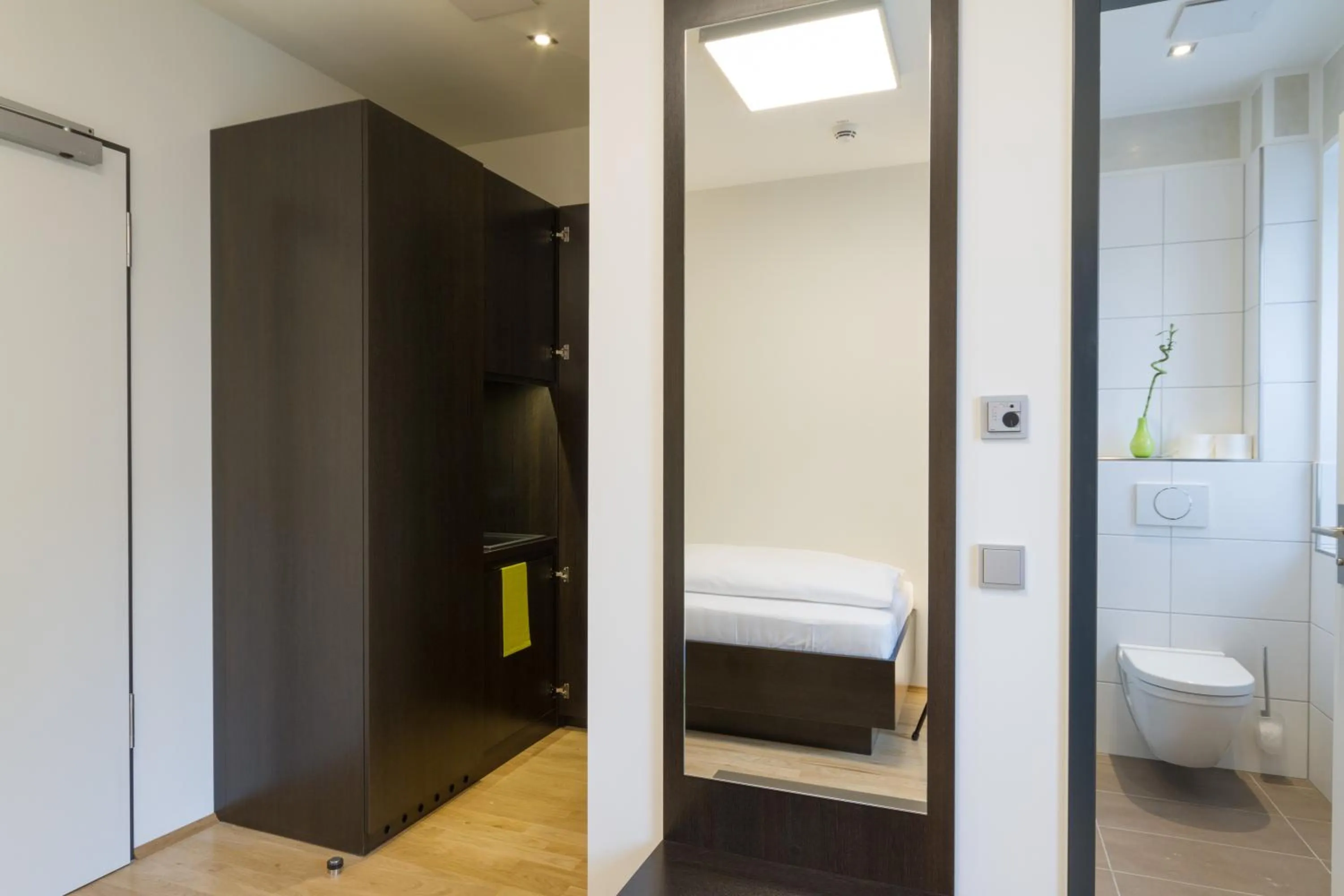 Kitchen or kitchenette, Bed in sevenDays Hotel BoardingHouse Mannheim