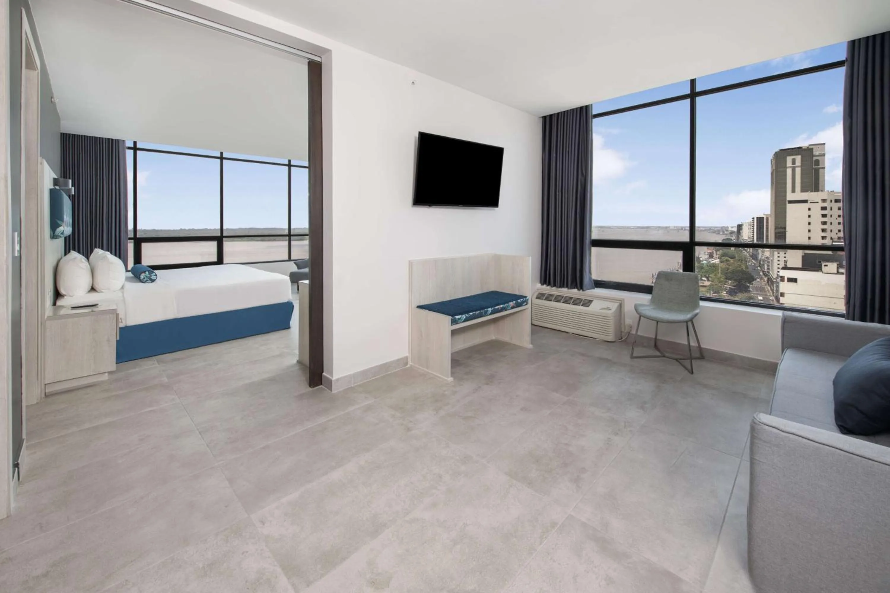 Living room, Bed in River Garden Hotel + Suites