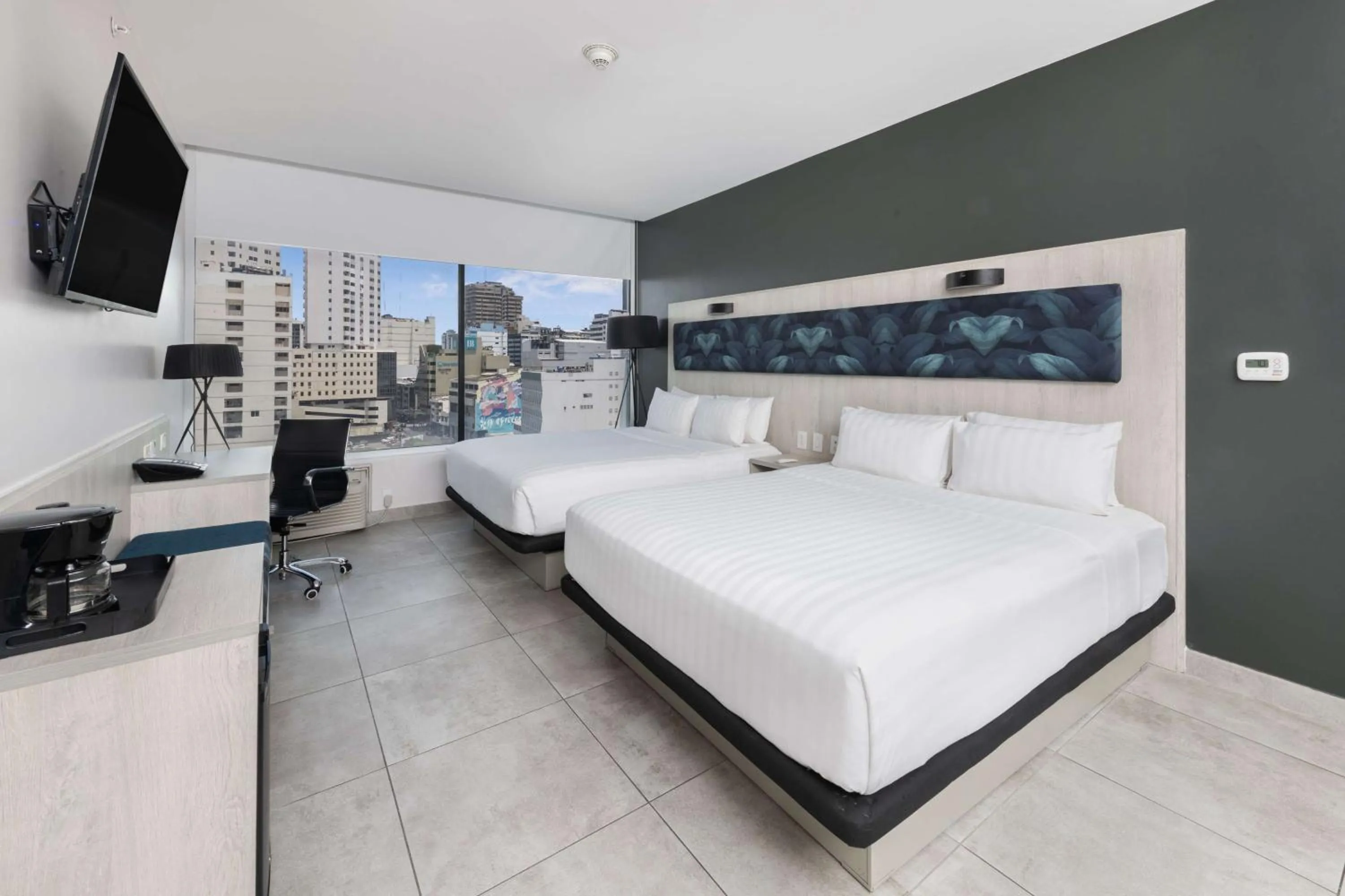 Bed in River Garden Hotel + Suites