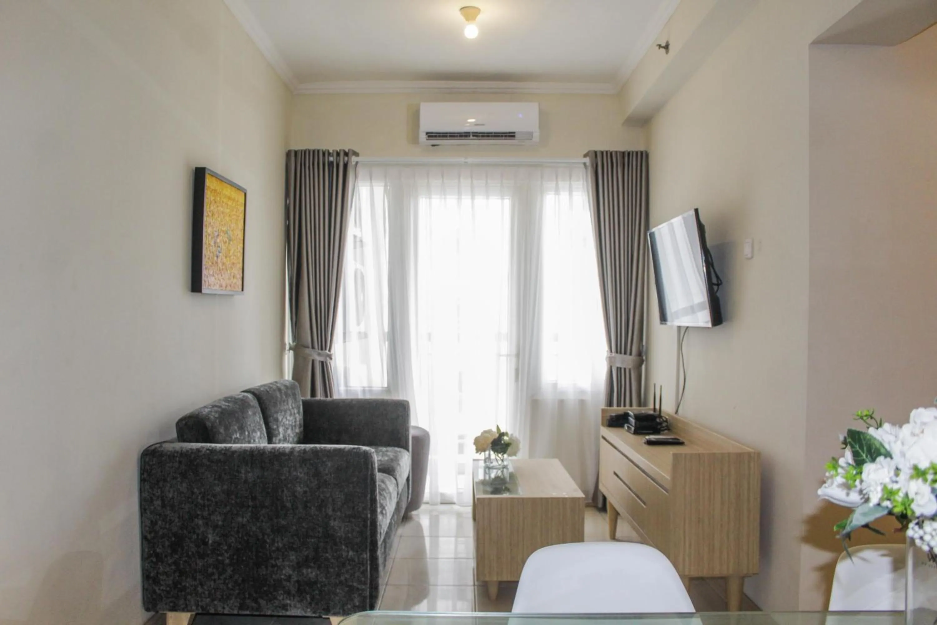 Living room in Homey 2BR Apartment at Grand Palace Kemayoran By Travelio