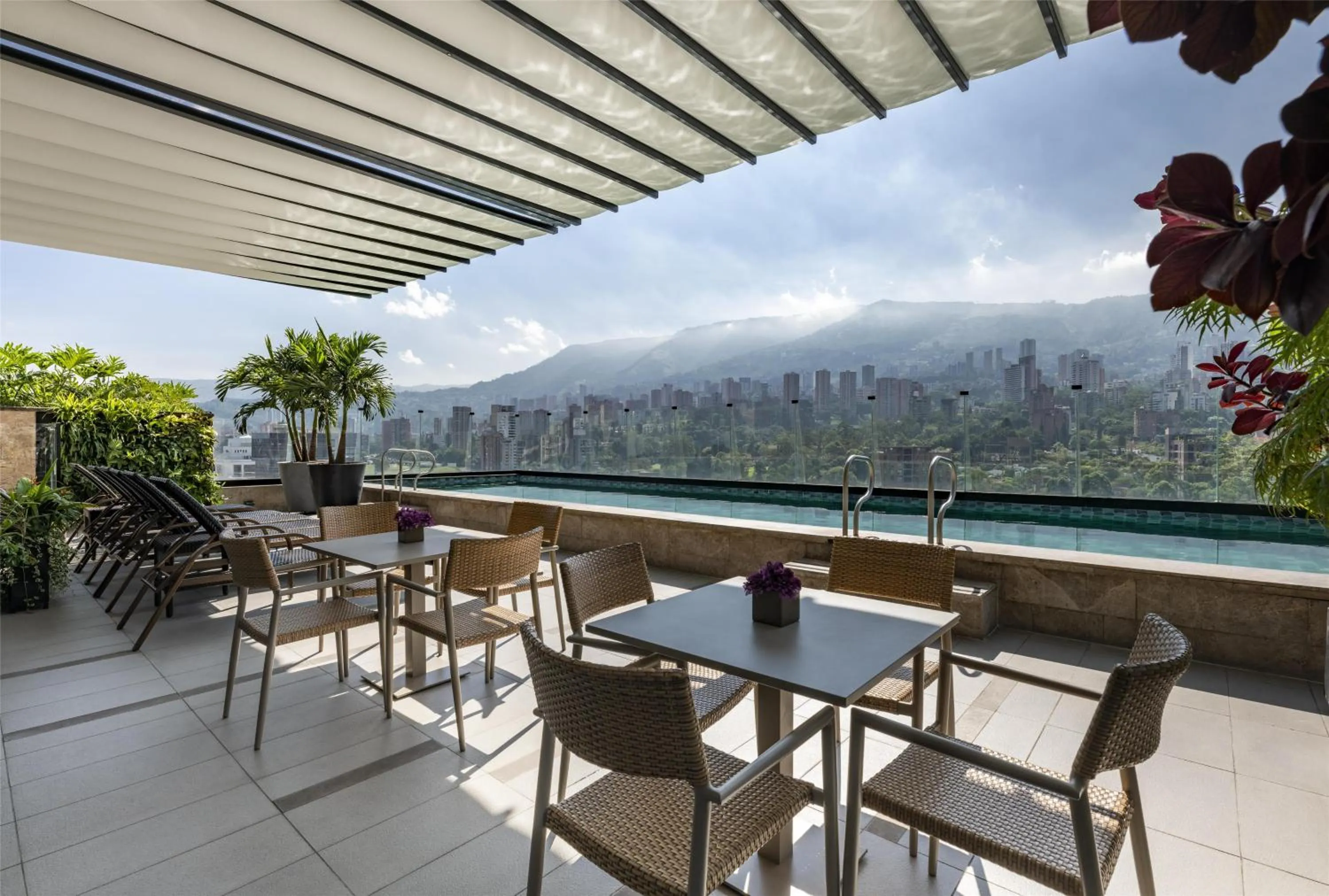 Pool view in York Medellin, Curio Collection by Hilton