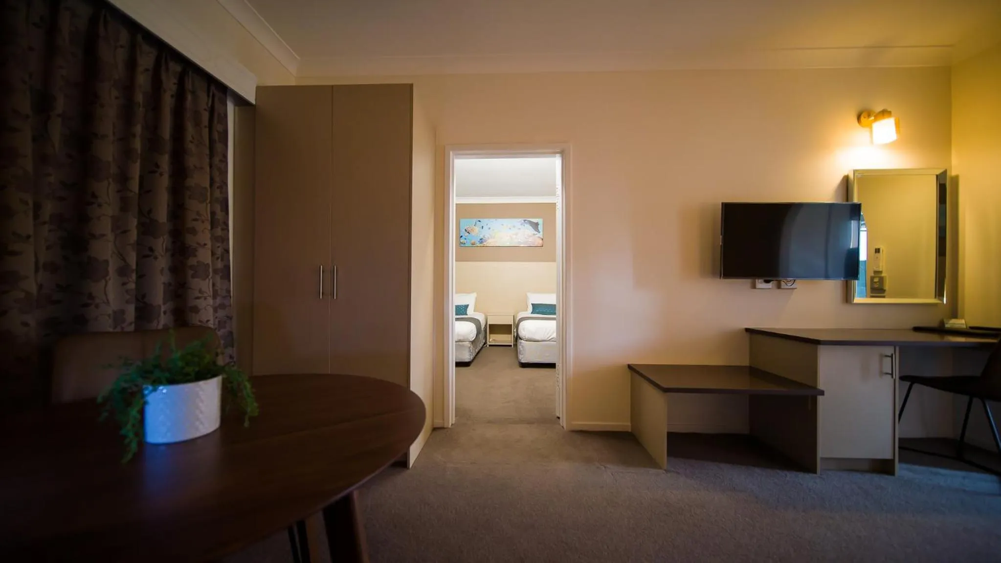Bedroom in Hamilton's Queanbeyan Motel