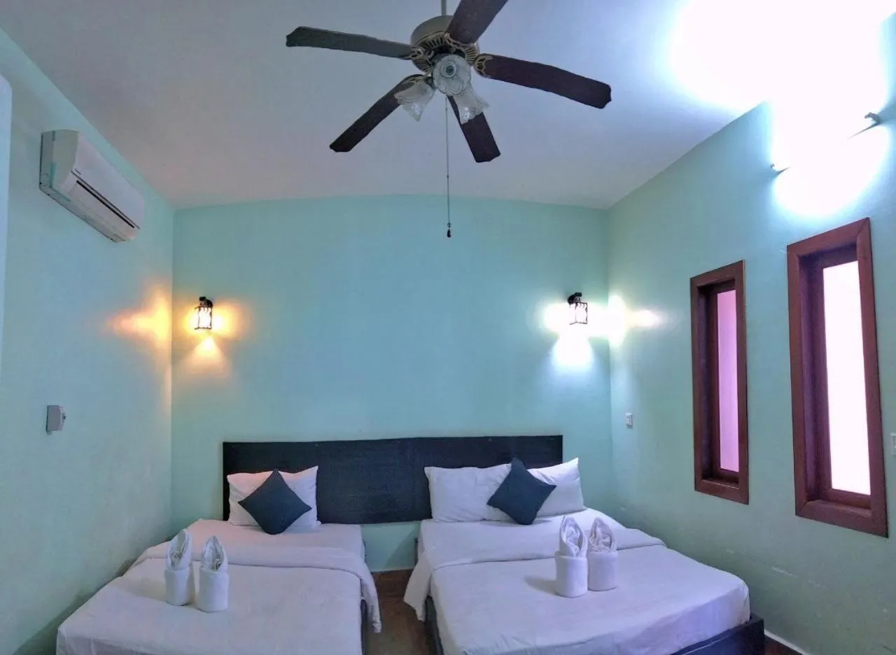 Bed in The Coconut House Hotel