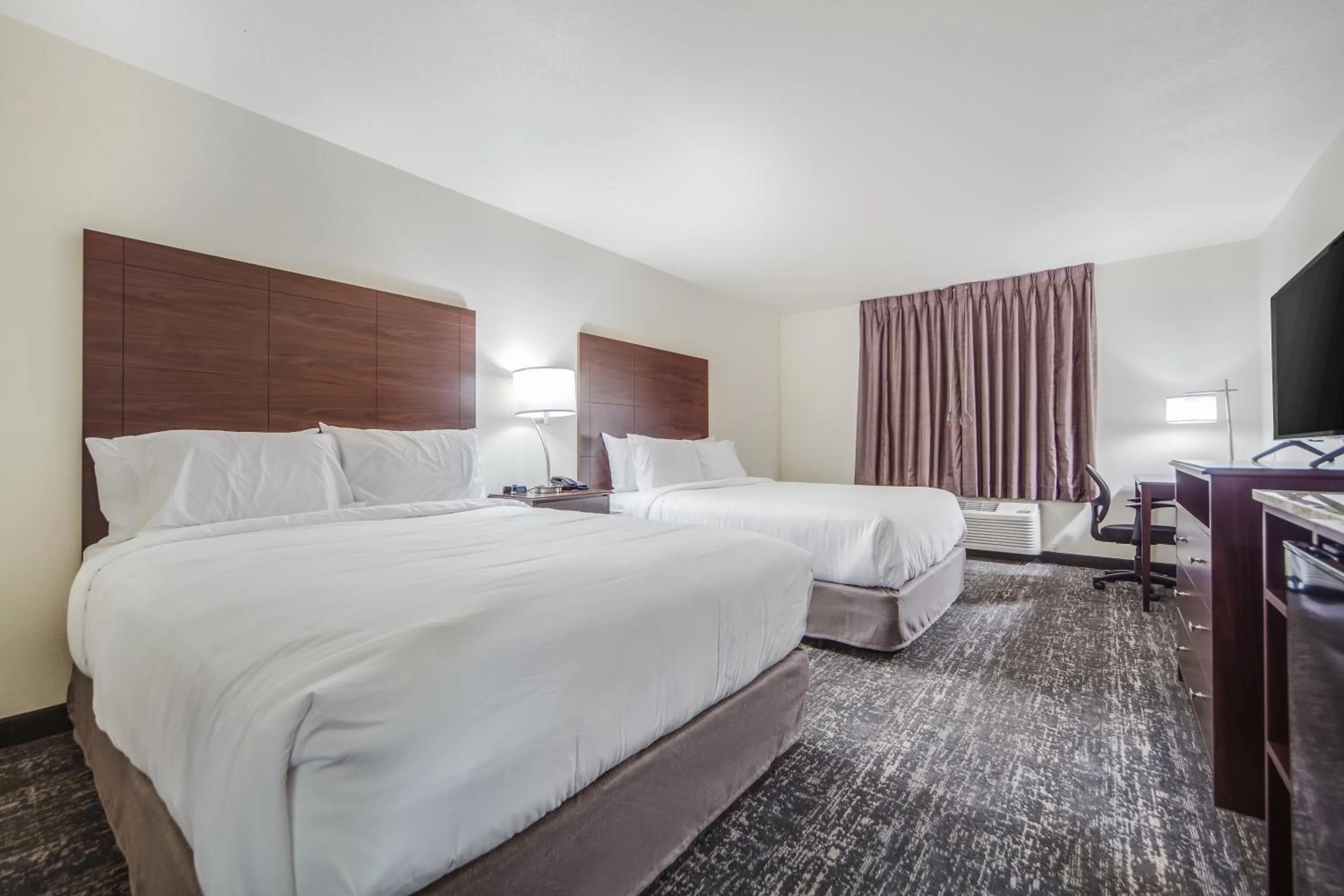 Bed in Cobblestone Hotel & Suites - Cozad