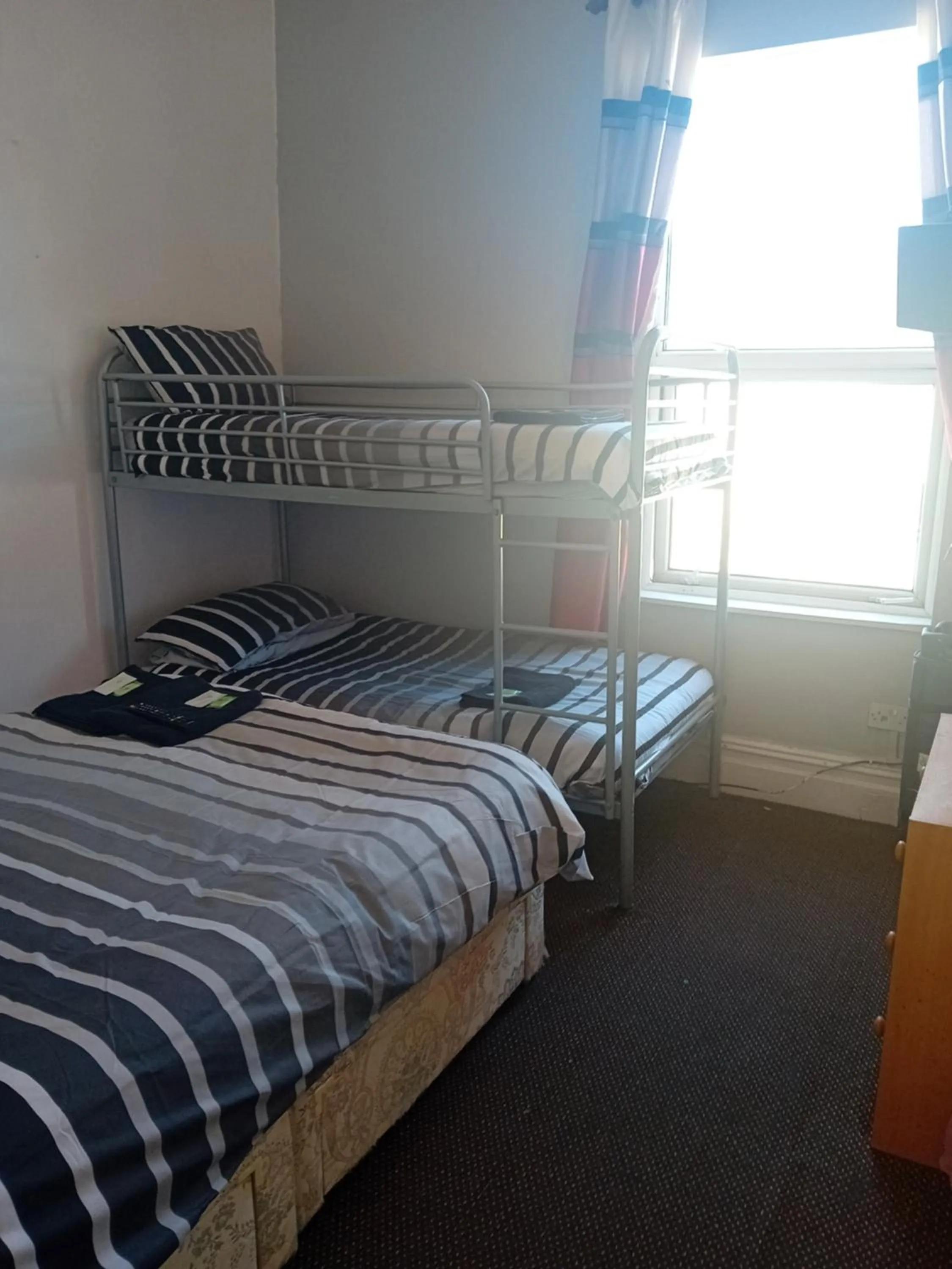 Bed in MyRoomz New Discovery Hotel