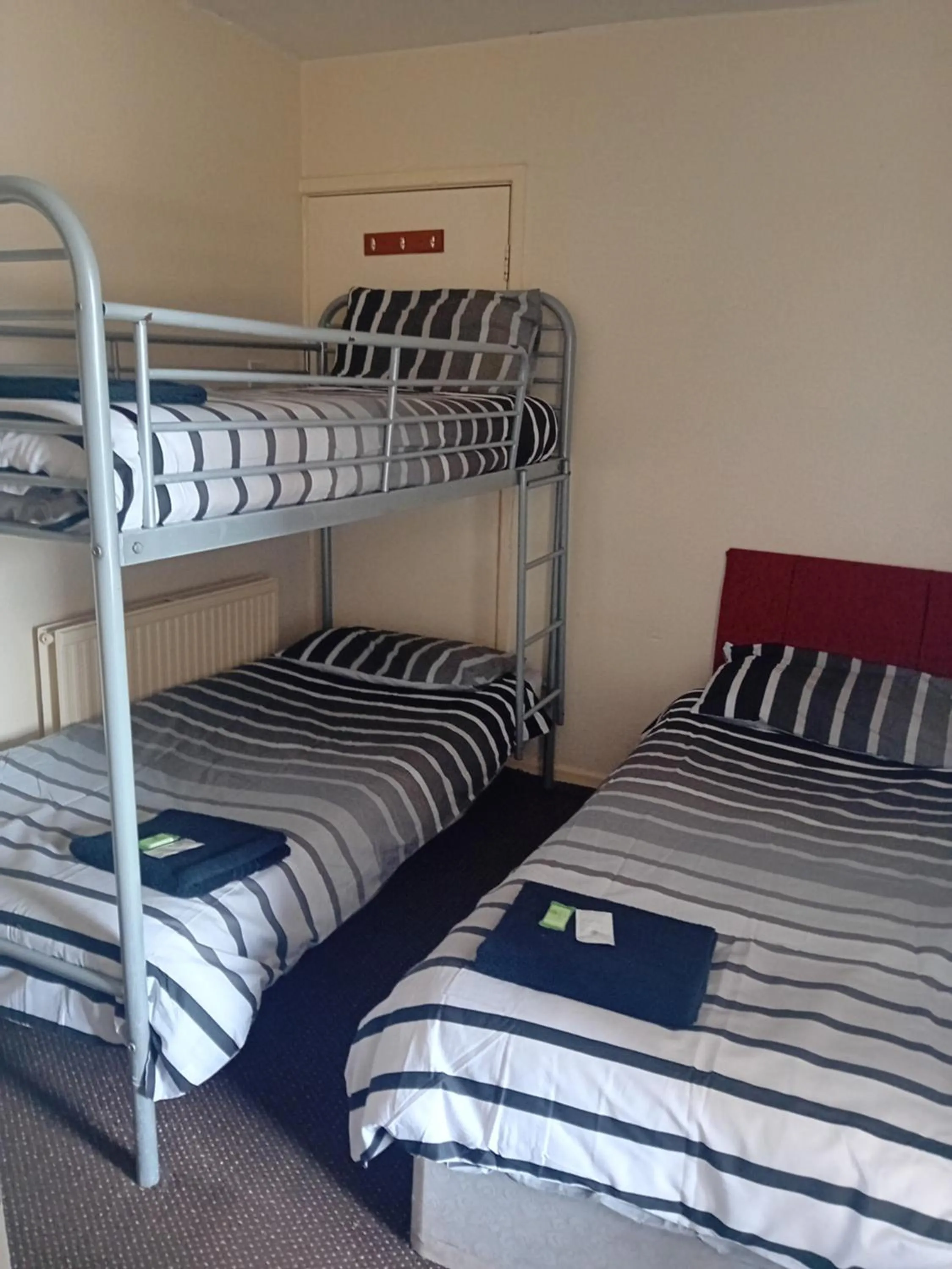 Bed in MyRoomz New Discovery Hotel