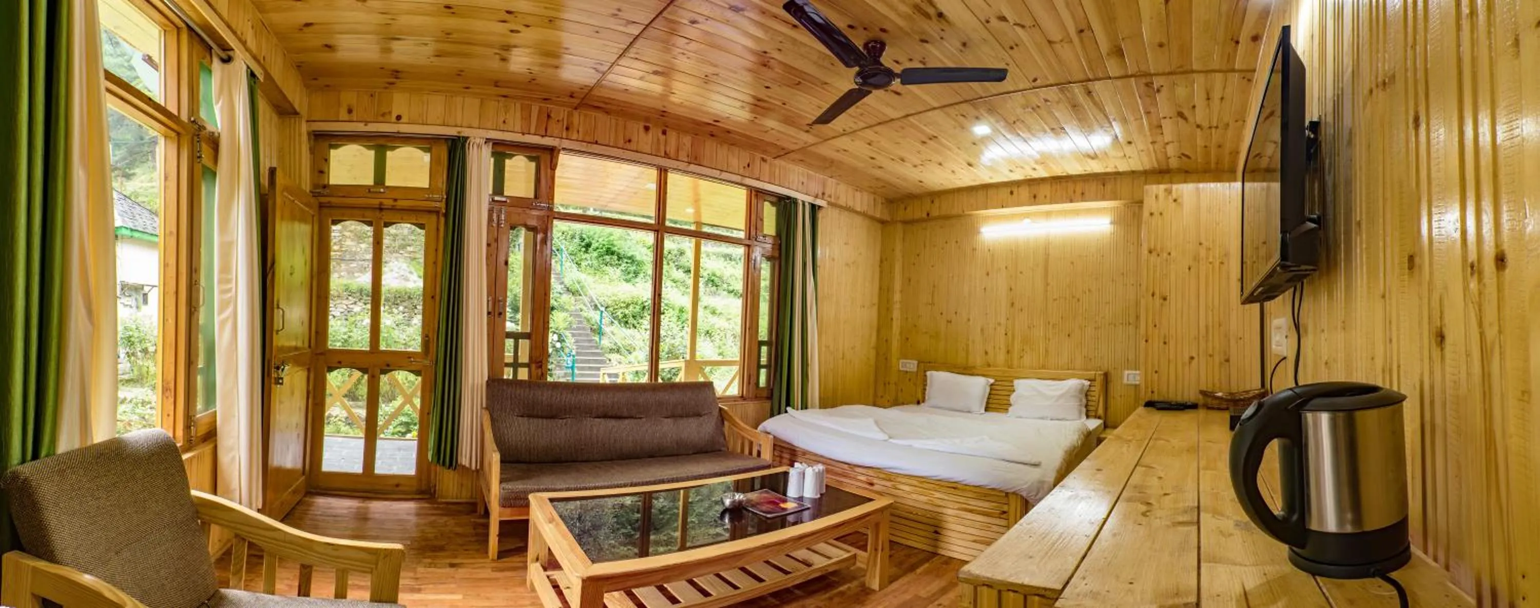 Bed in Parvati Kuteer riverside resort