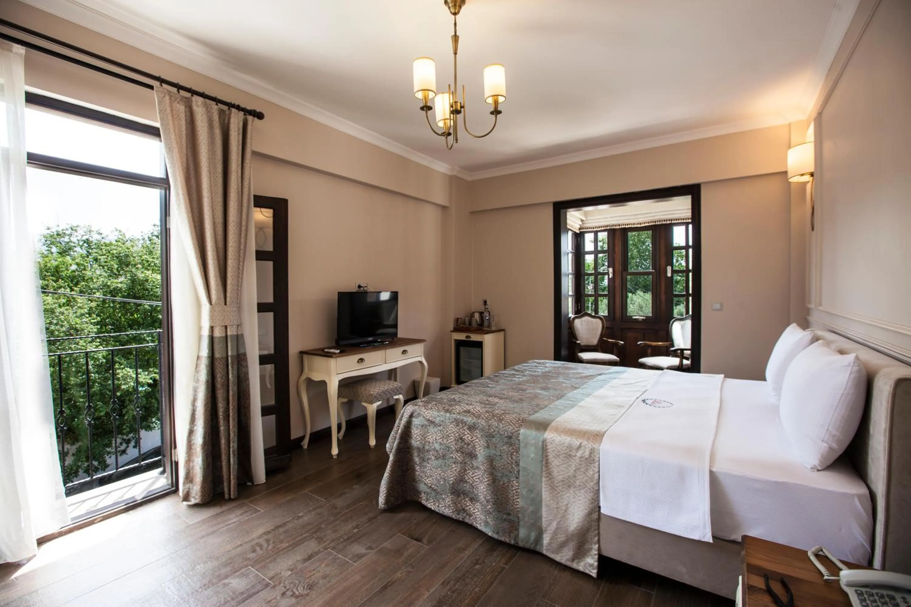 Communal lounge/ TV room, Bed in Livia Garden Hotel