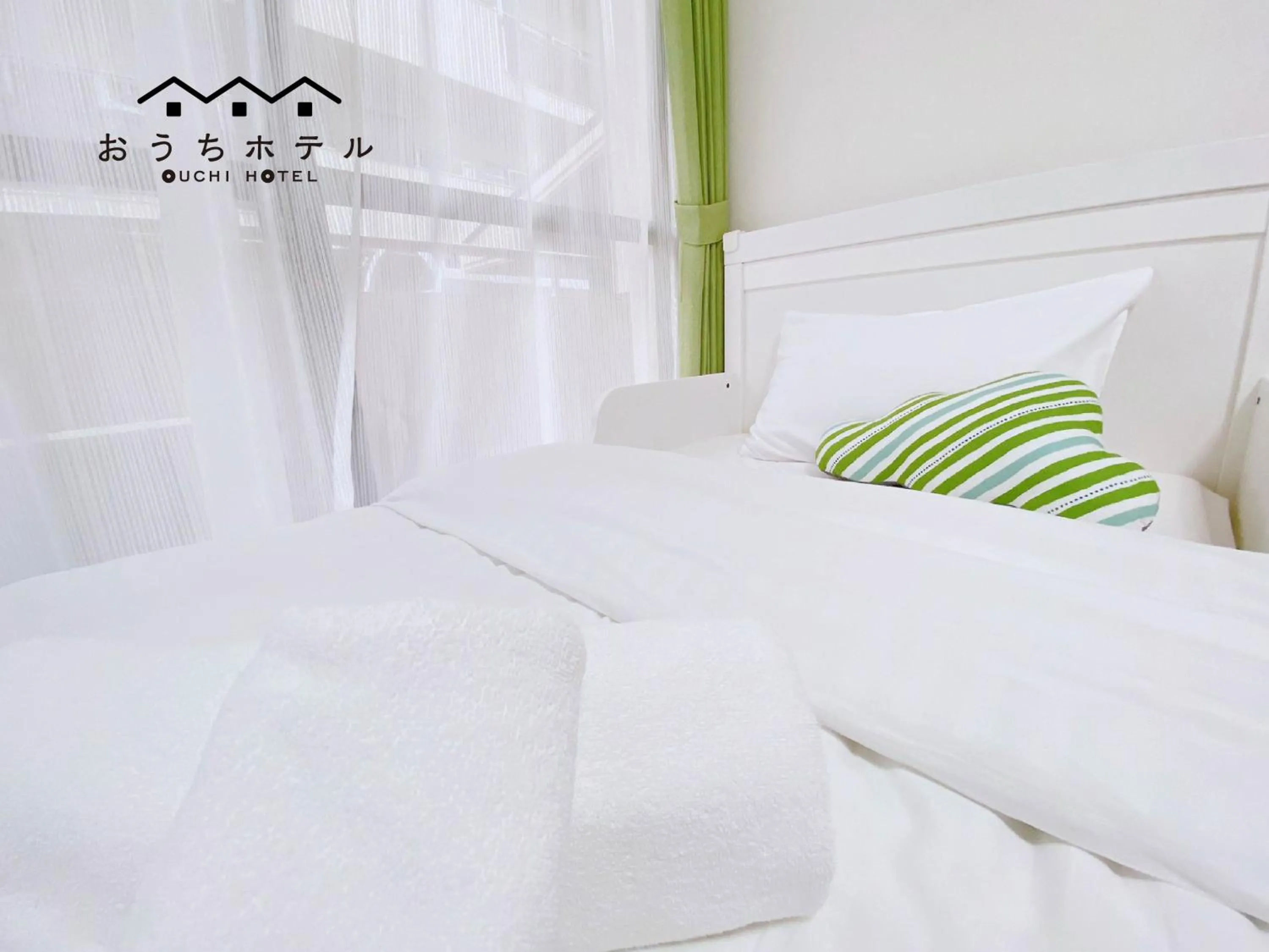 Bed in OUCHI HOTEL Itsukaichi