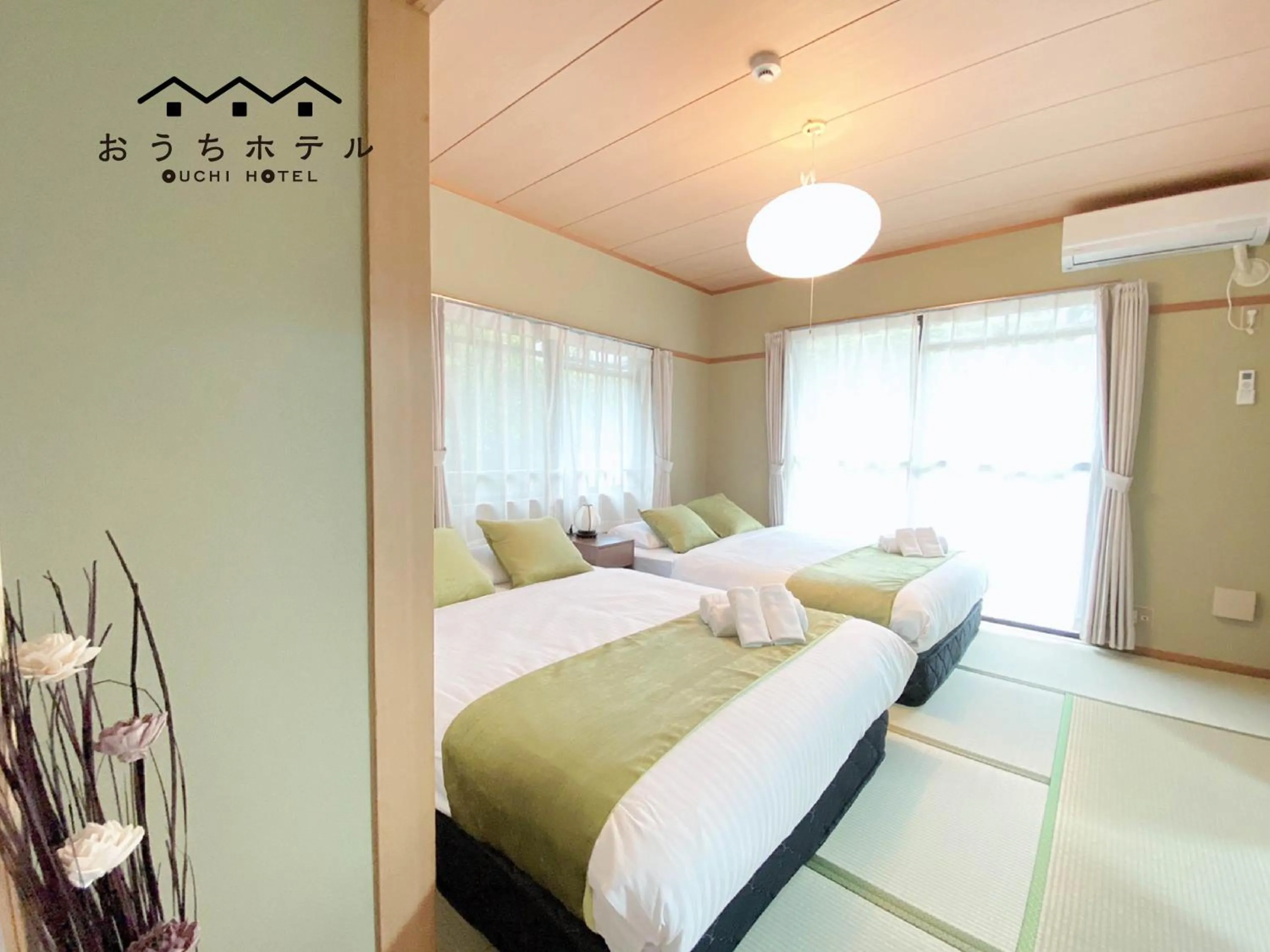 Bed in OUCHI HOTEL Itsukaichi