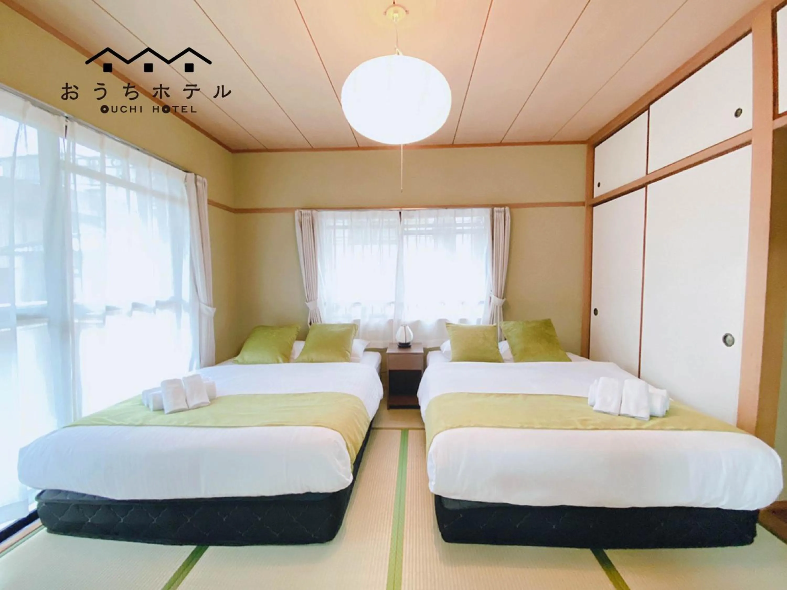 Bed in OUCHI HOTEL Itsukaichi