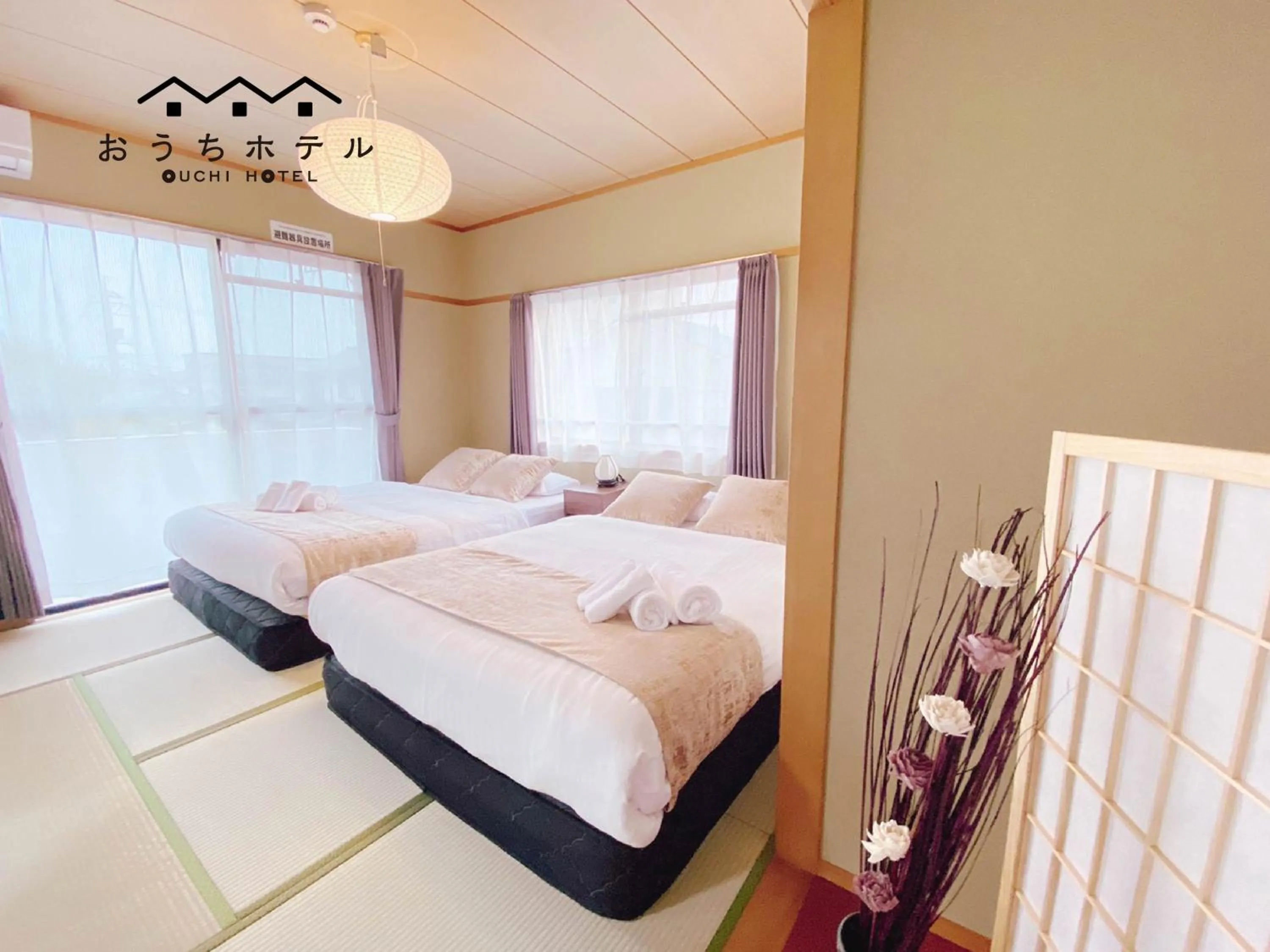 Bed in OUCHI HOTEL Itsukaichi