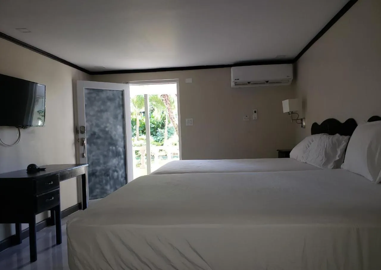 Bed in Sand and Blue Seas