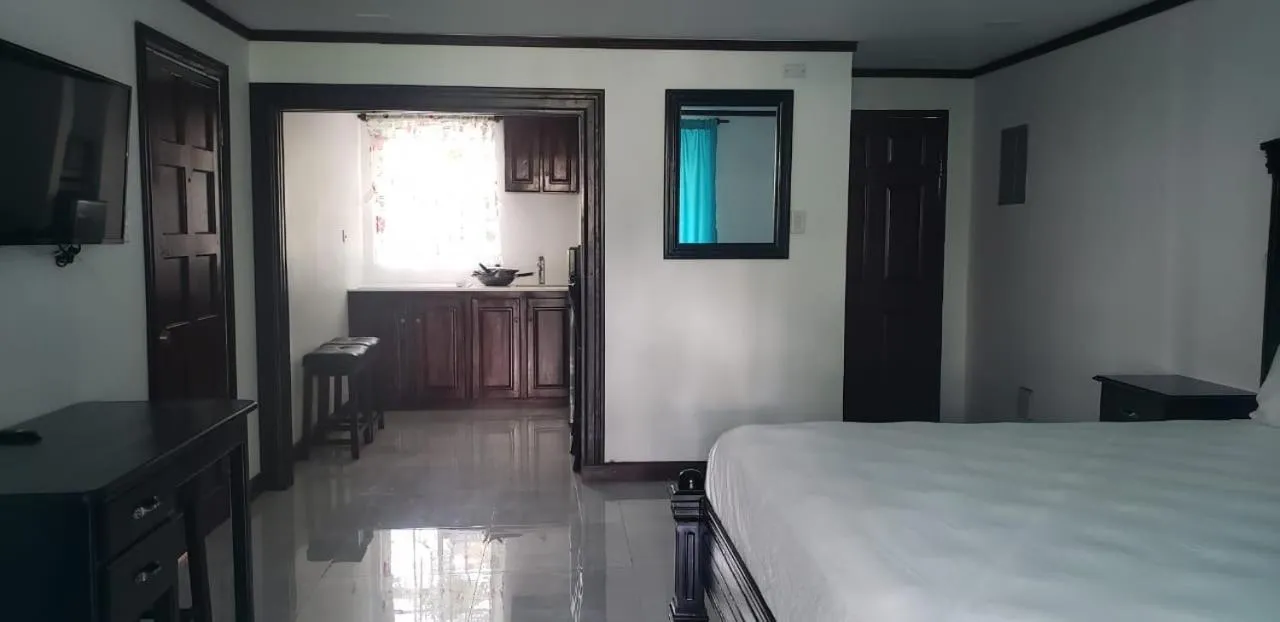 Photo of the whole room, Bed in Sand and Blue Seas