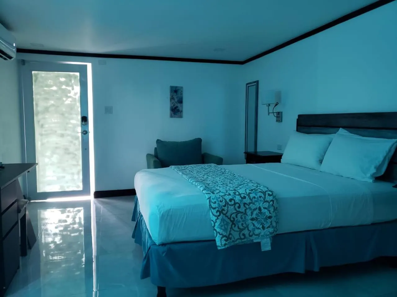 Photo of the whole room, Bed in Sand and Blue Seas