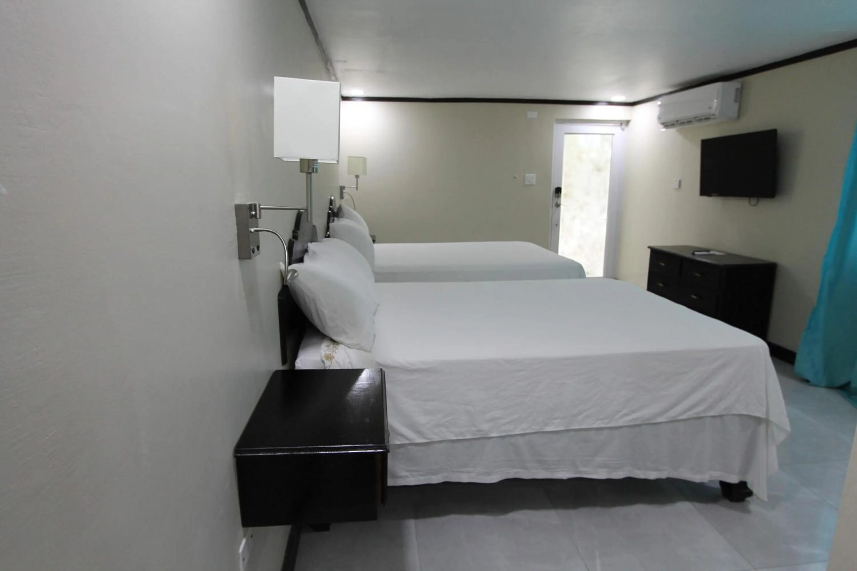 Bed in Sand and Blue Seas