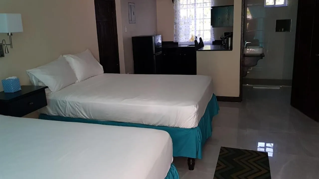 Bed in Sand and Blue Seas