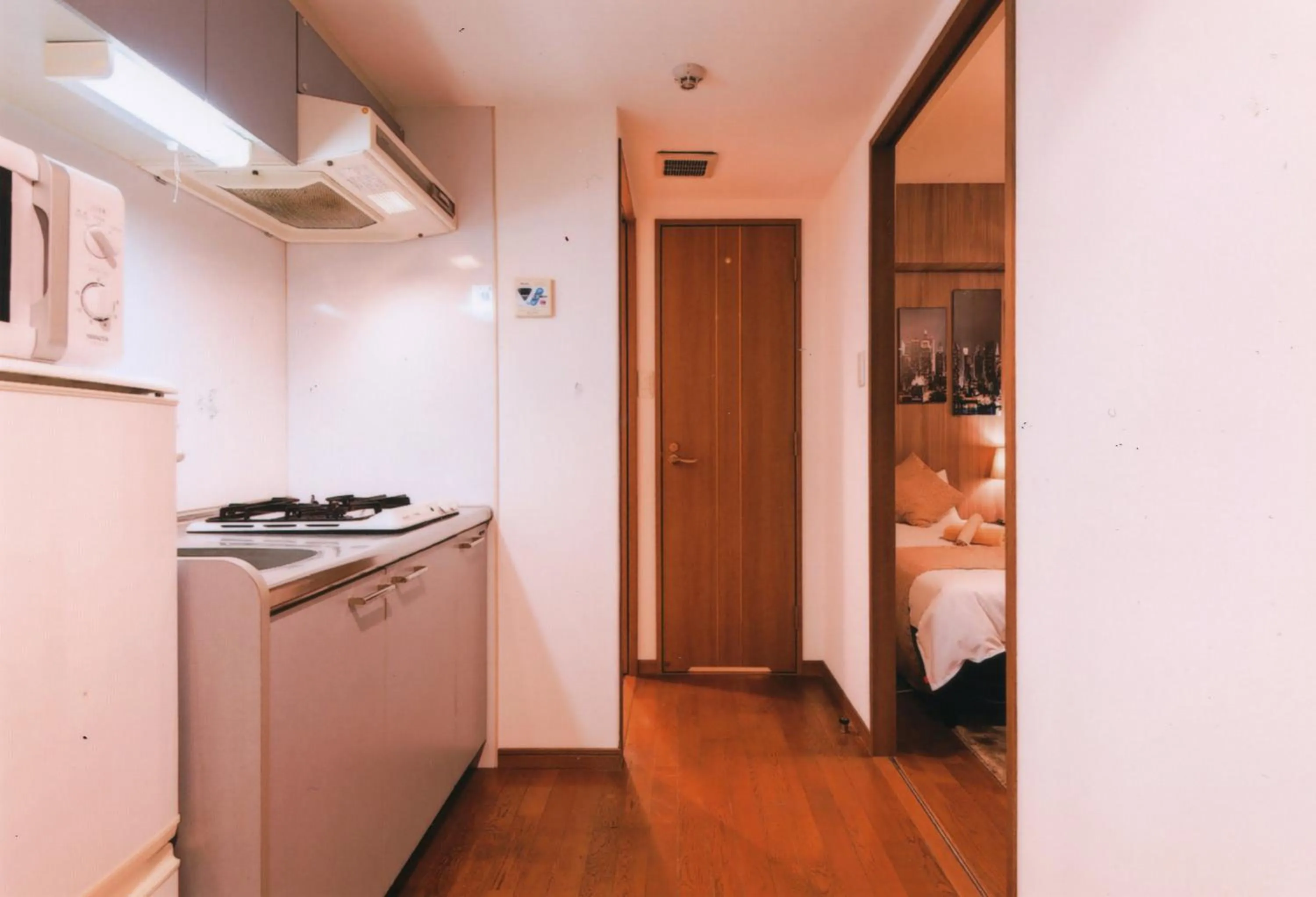 Kitchen or kitchenette, Bed in Sakura Sands Hotel