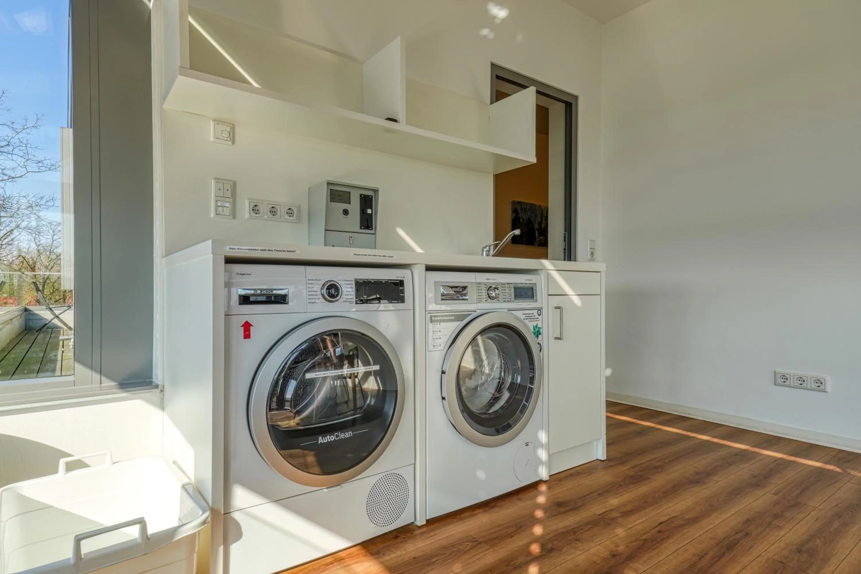 washing machine in NiceToStay by Fairway Hotels