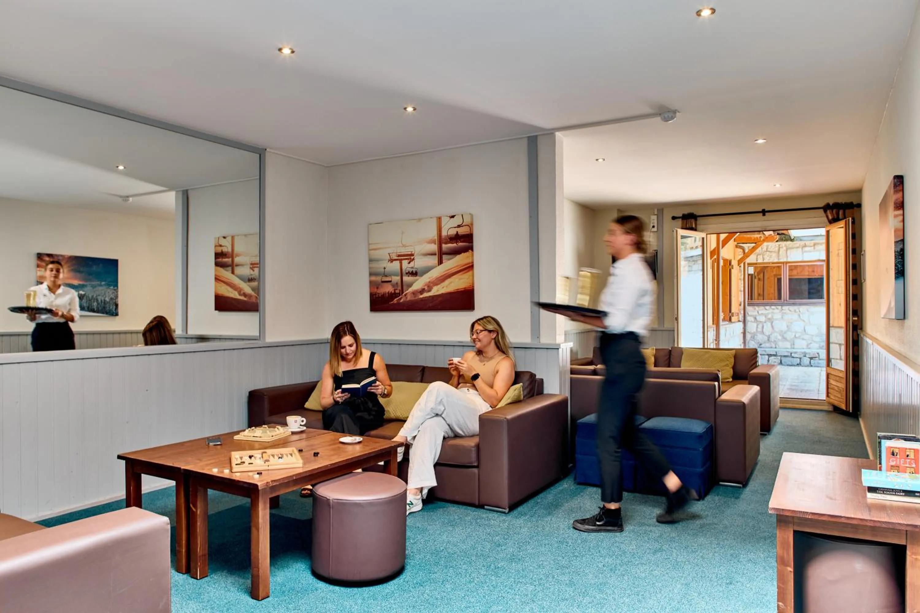 Communal lounge/ TV room in Hôtel Les Grangettes