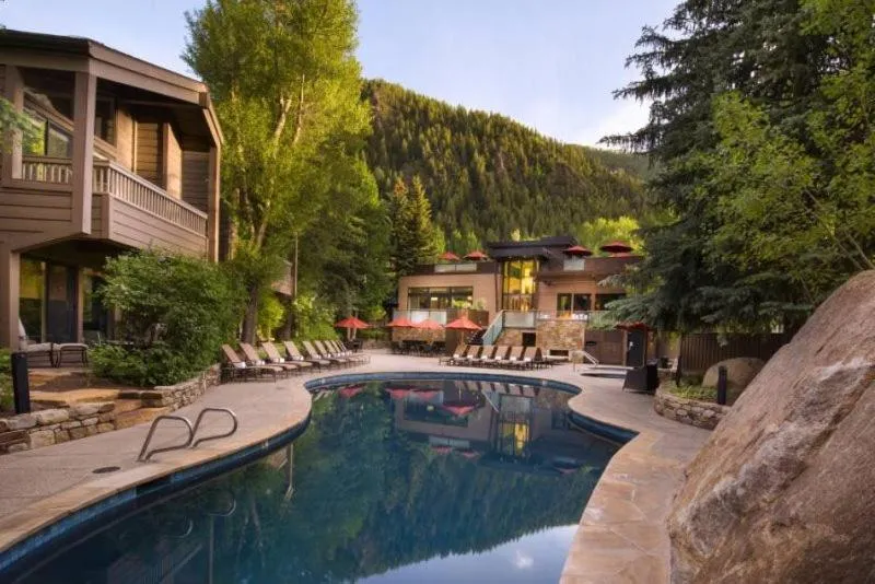 Property building in Luxury 2 Bedroom Downtown Aspen Vacation Rental With Access To A Heated Pool, Hot Tubs, Game Room And Spa